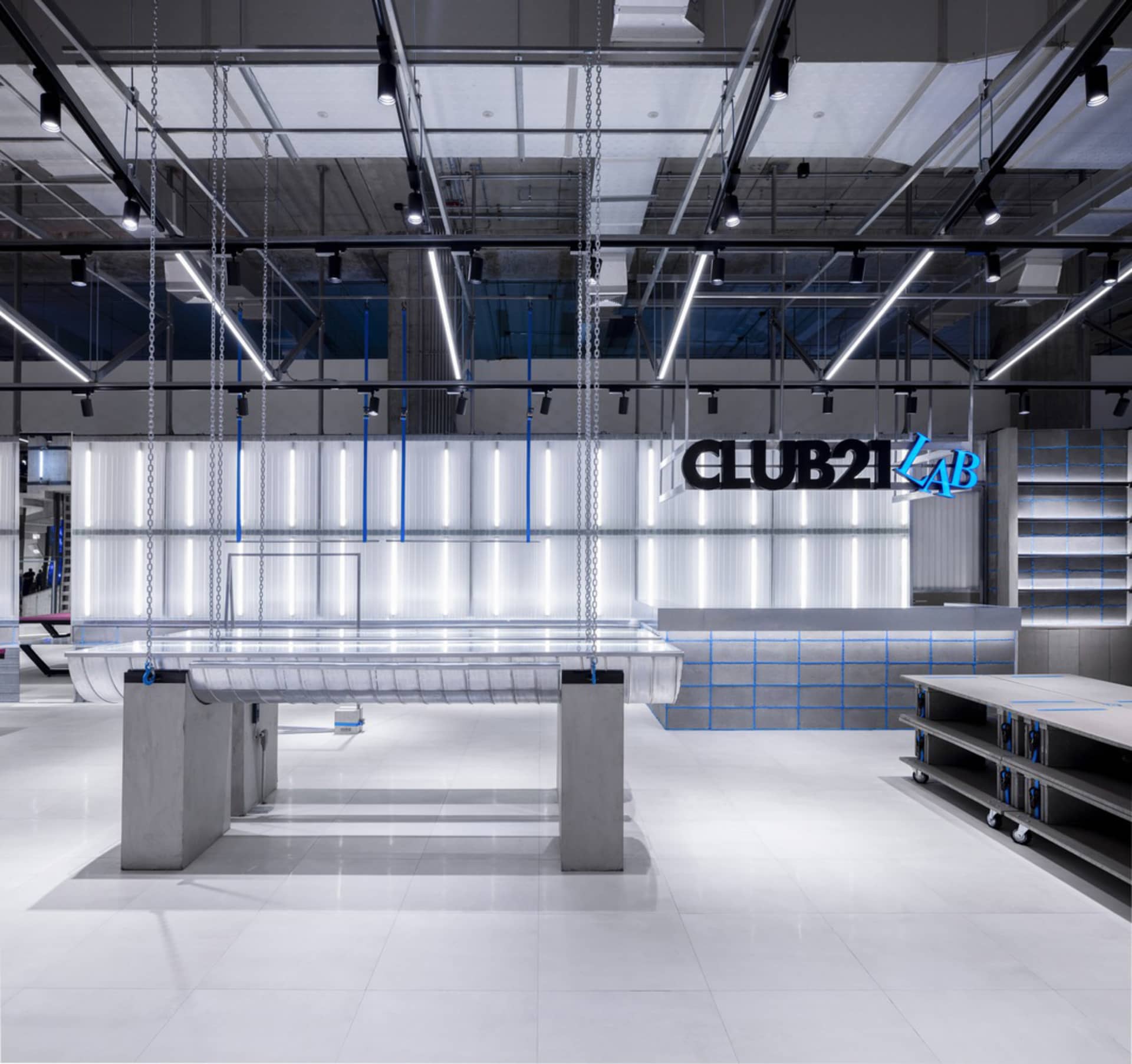 Modern minimalist retail space featuring concrete, glass, and metal materials