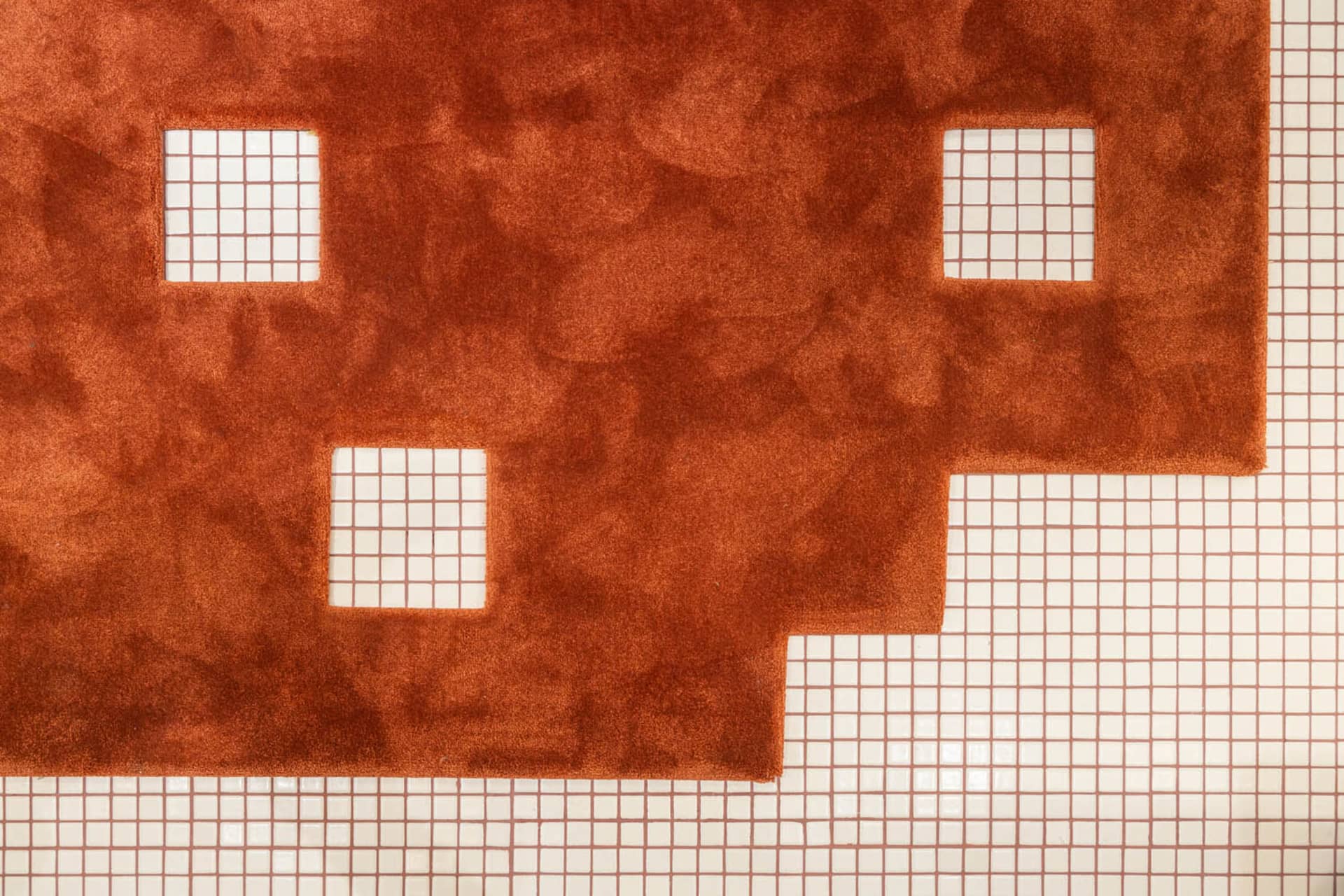 A modern floor plan featuring an orange vinyl grid design.