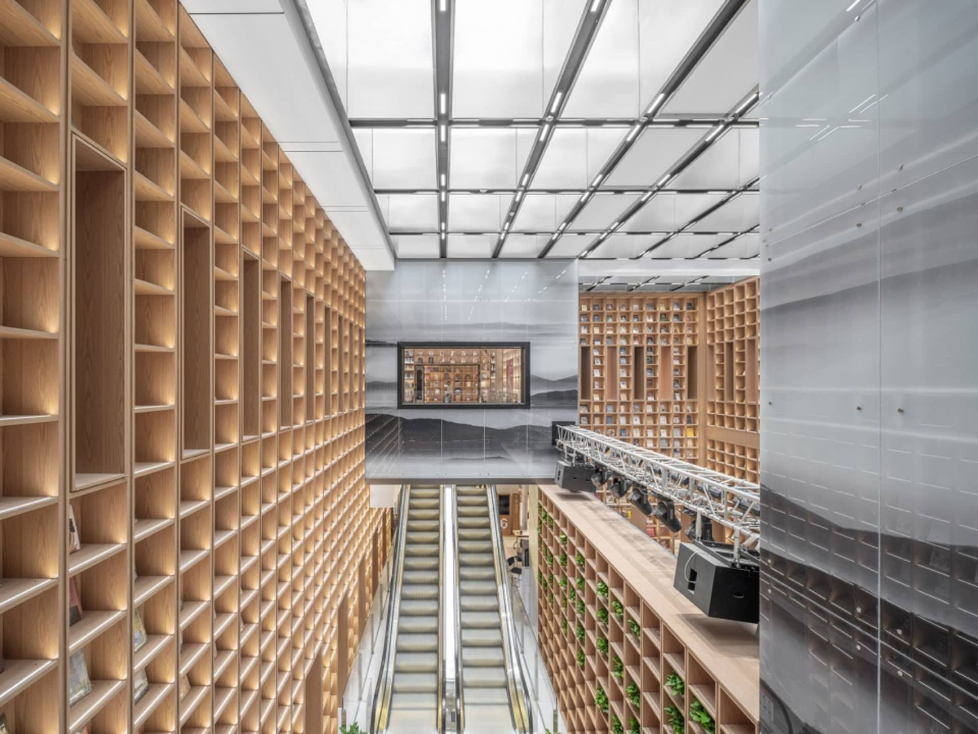 Photo of a spacious library with wooden shelves and modern design elements.
