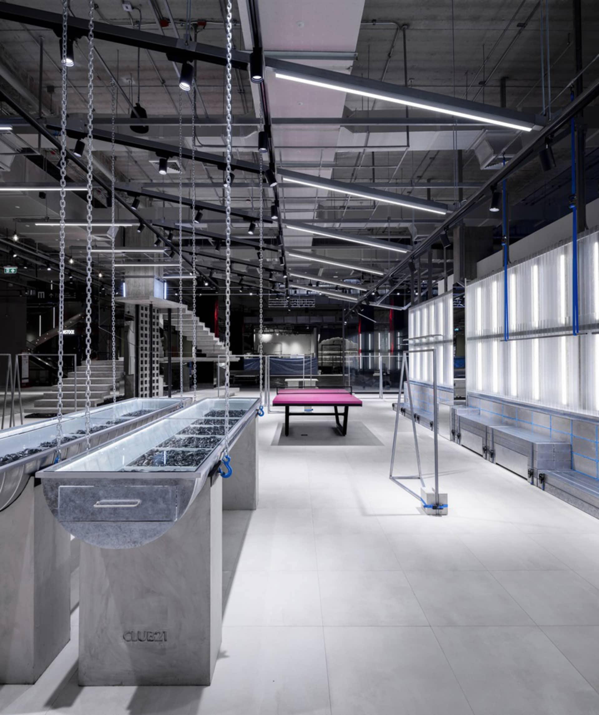 A modern retail space featuring concrete finishes and minimalist design.