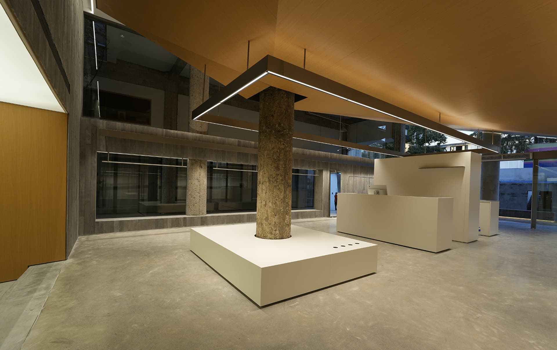 Modern office space featuring concrete columns and minimalist design.
