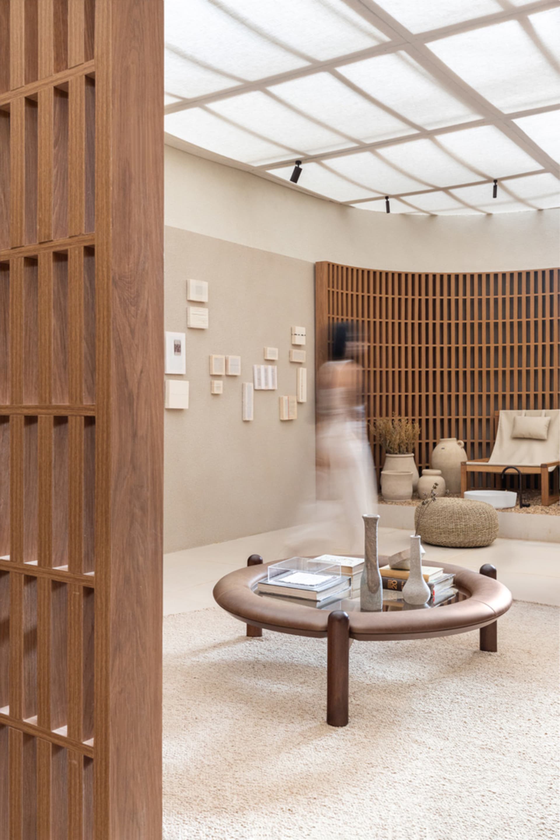 A minimalist living room with wooden furniture, a round table, and a modern vibe.