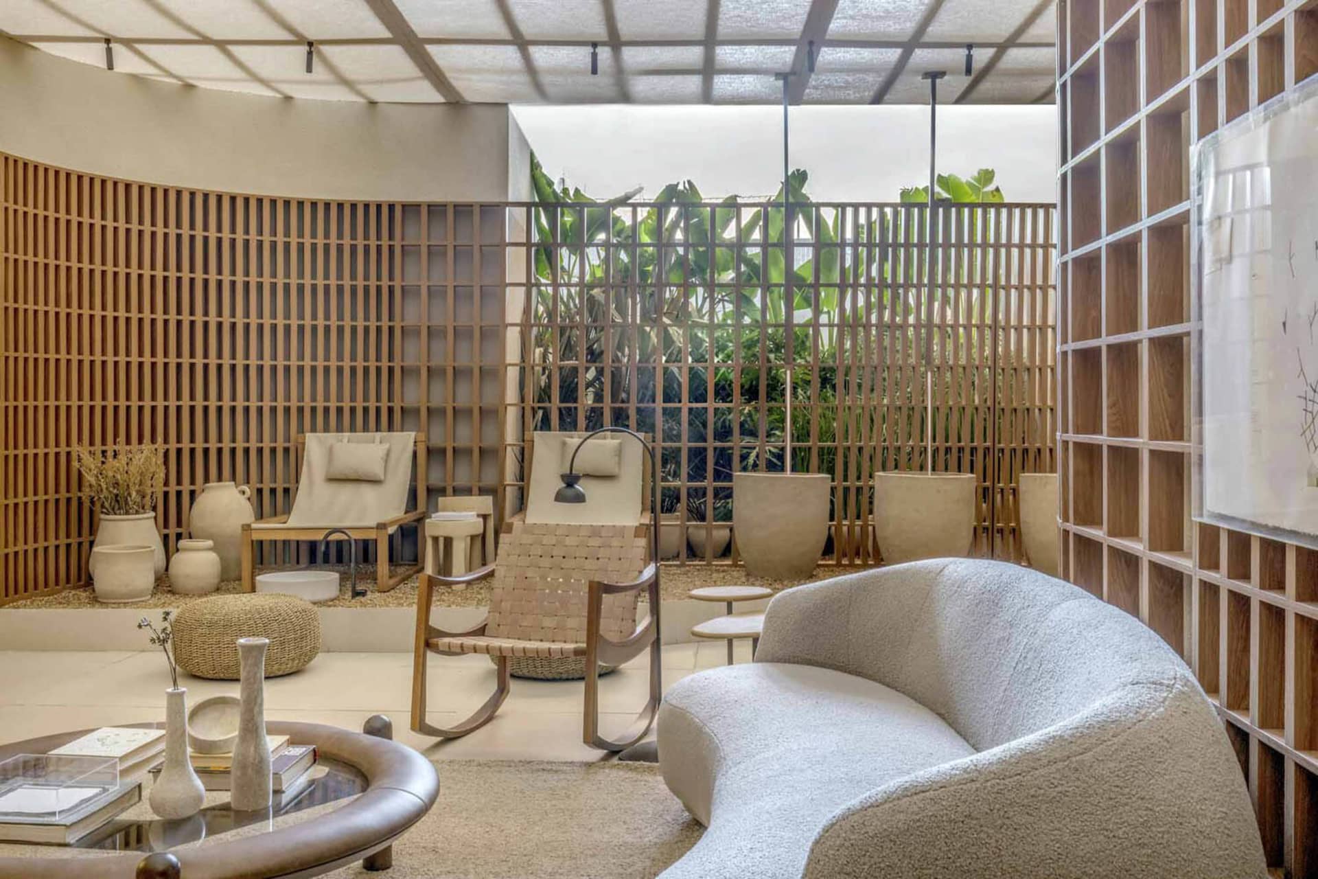 Modern living room with wooden accents, concrete floor, and fabric seating.