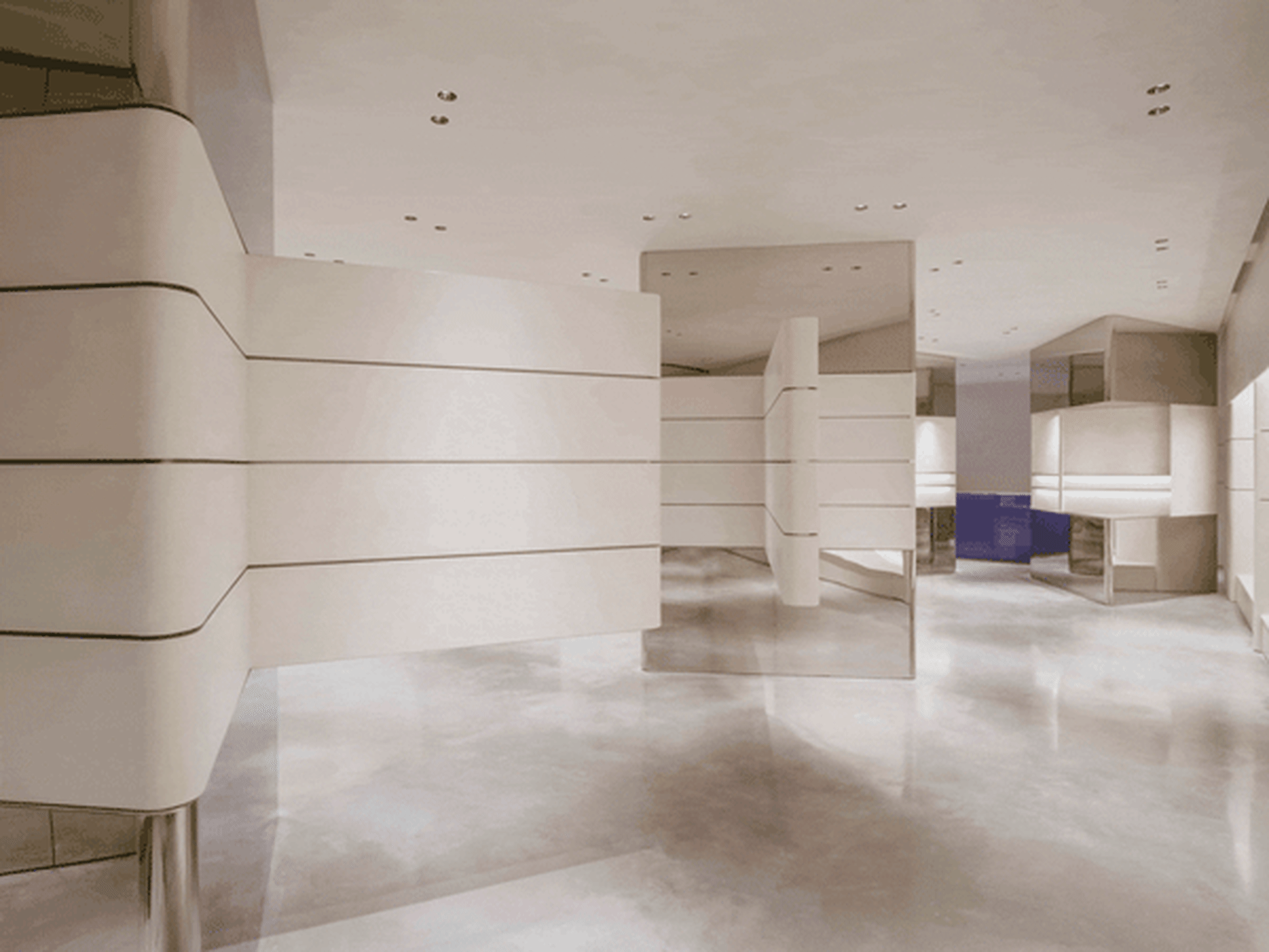 Modern, minimalist office space with concrete walls and floor.