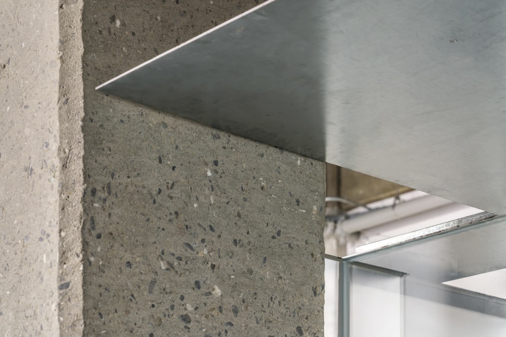 Modern interior design featuring metal walls and concrete floor.