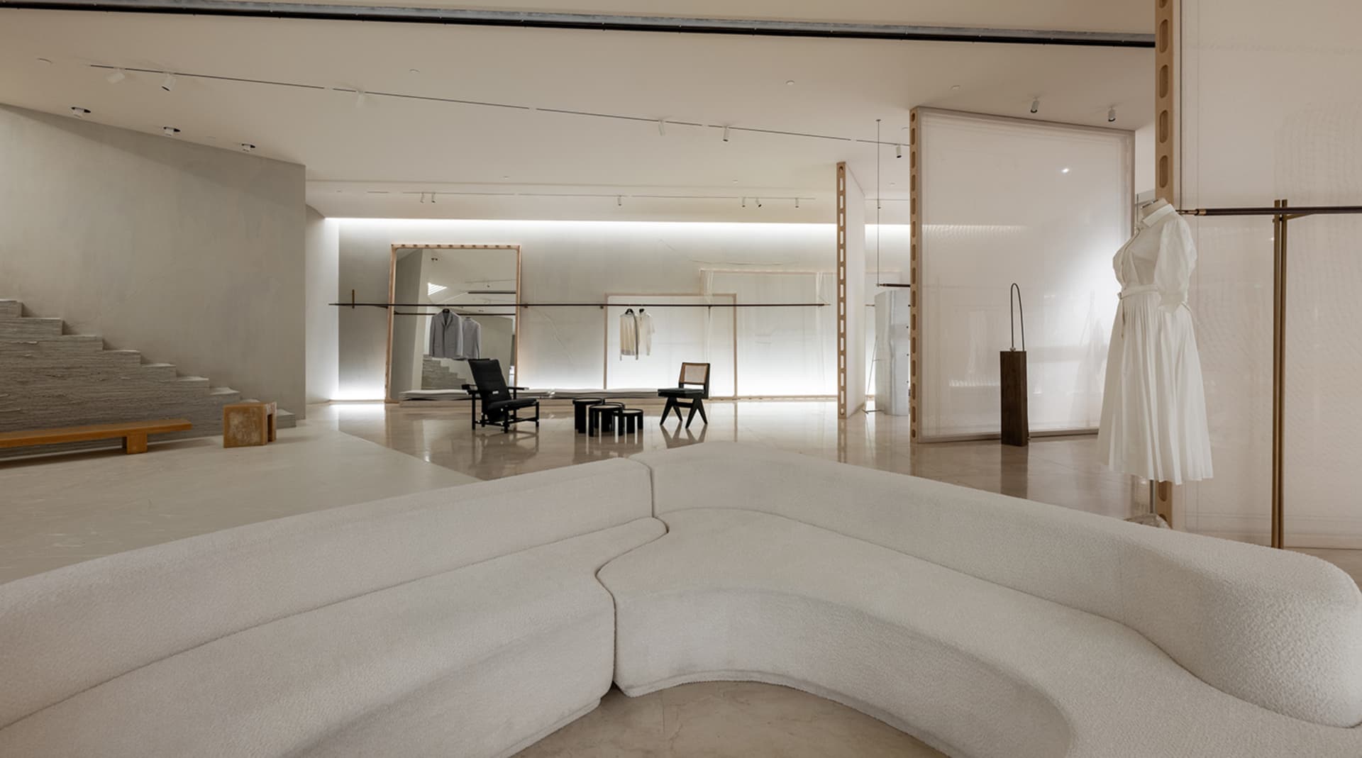 A modern retail store with a minimalist white space design, featuring a clean and uncluttered environment.