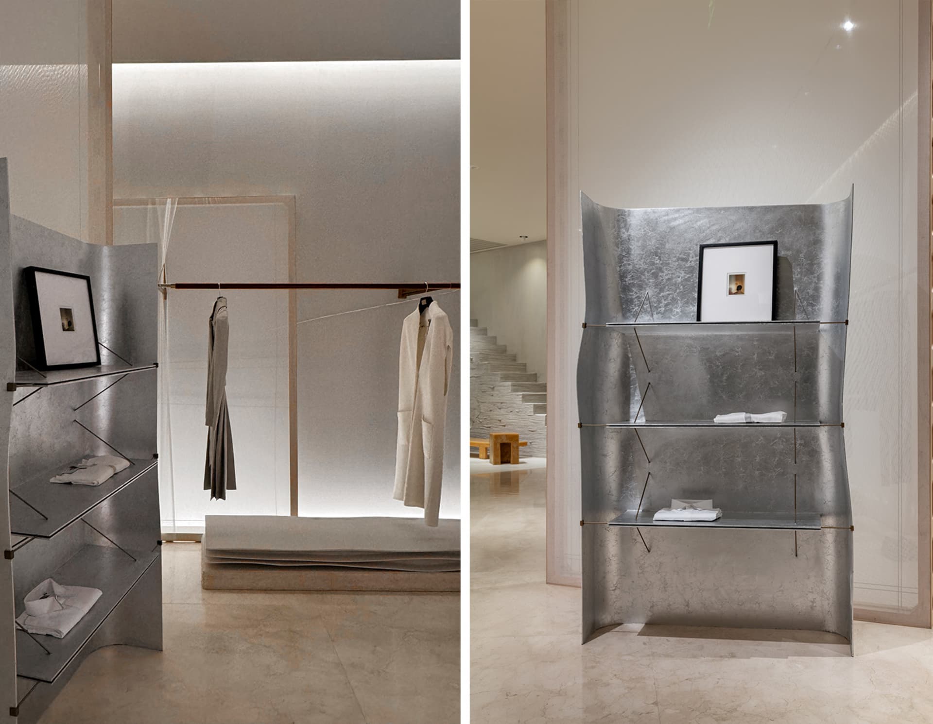 Modern minimalist clothing retail space with metal shelving.
