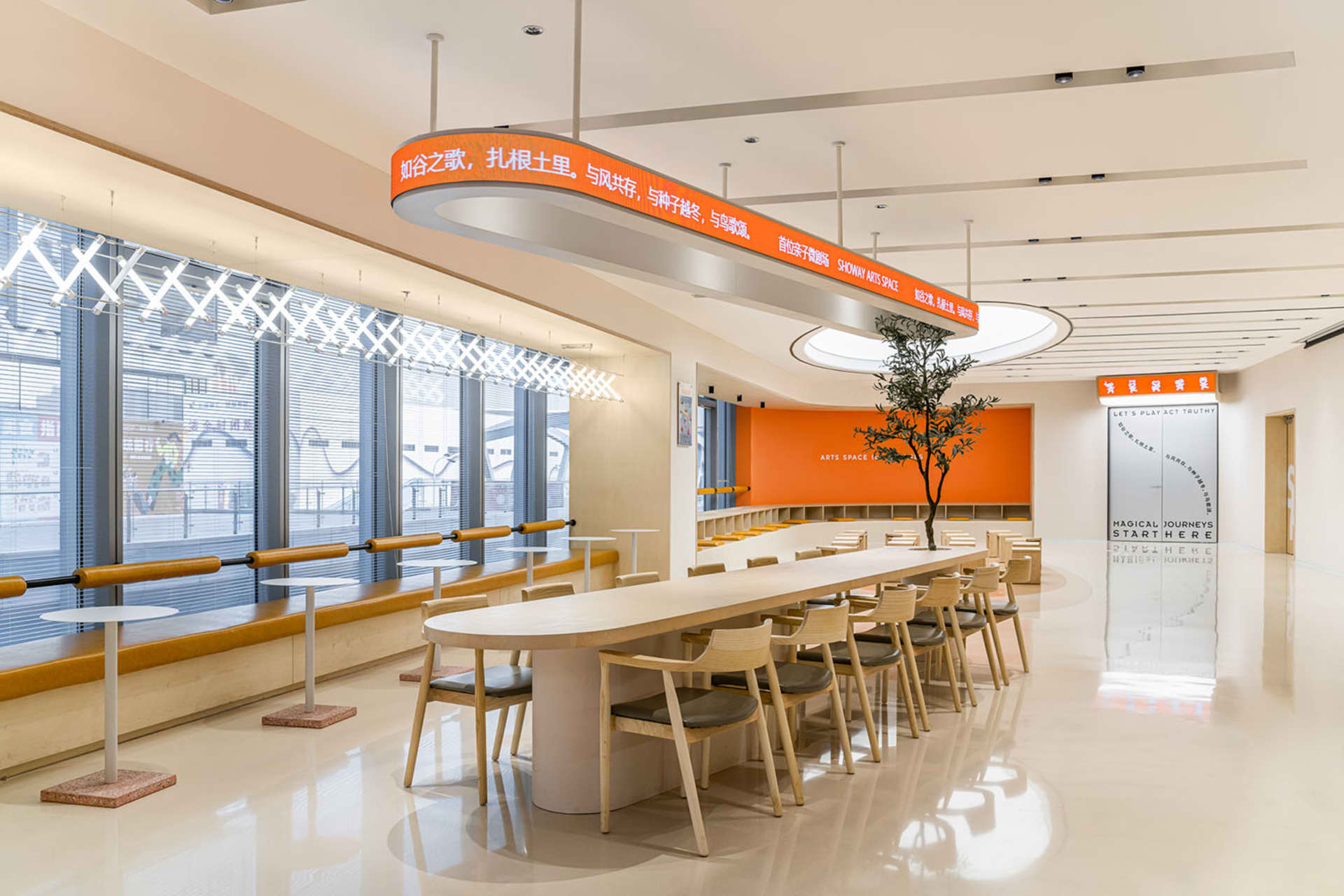 Modern industrial style coffee shop interior with wooden tables, glass walls, and metal accents.