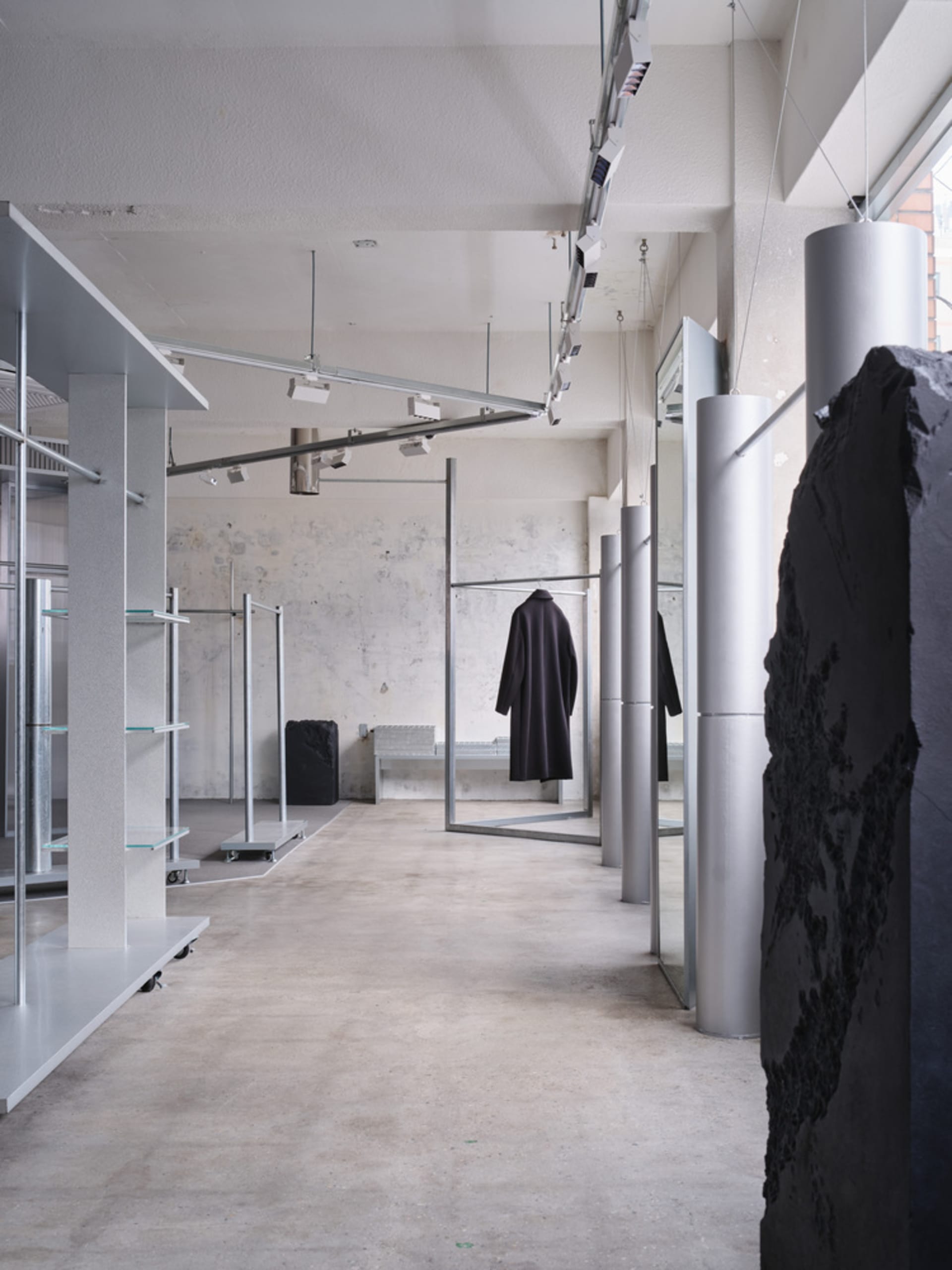 Modern shopping center interior with concrete flooring and minimalist design.