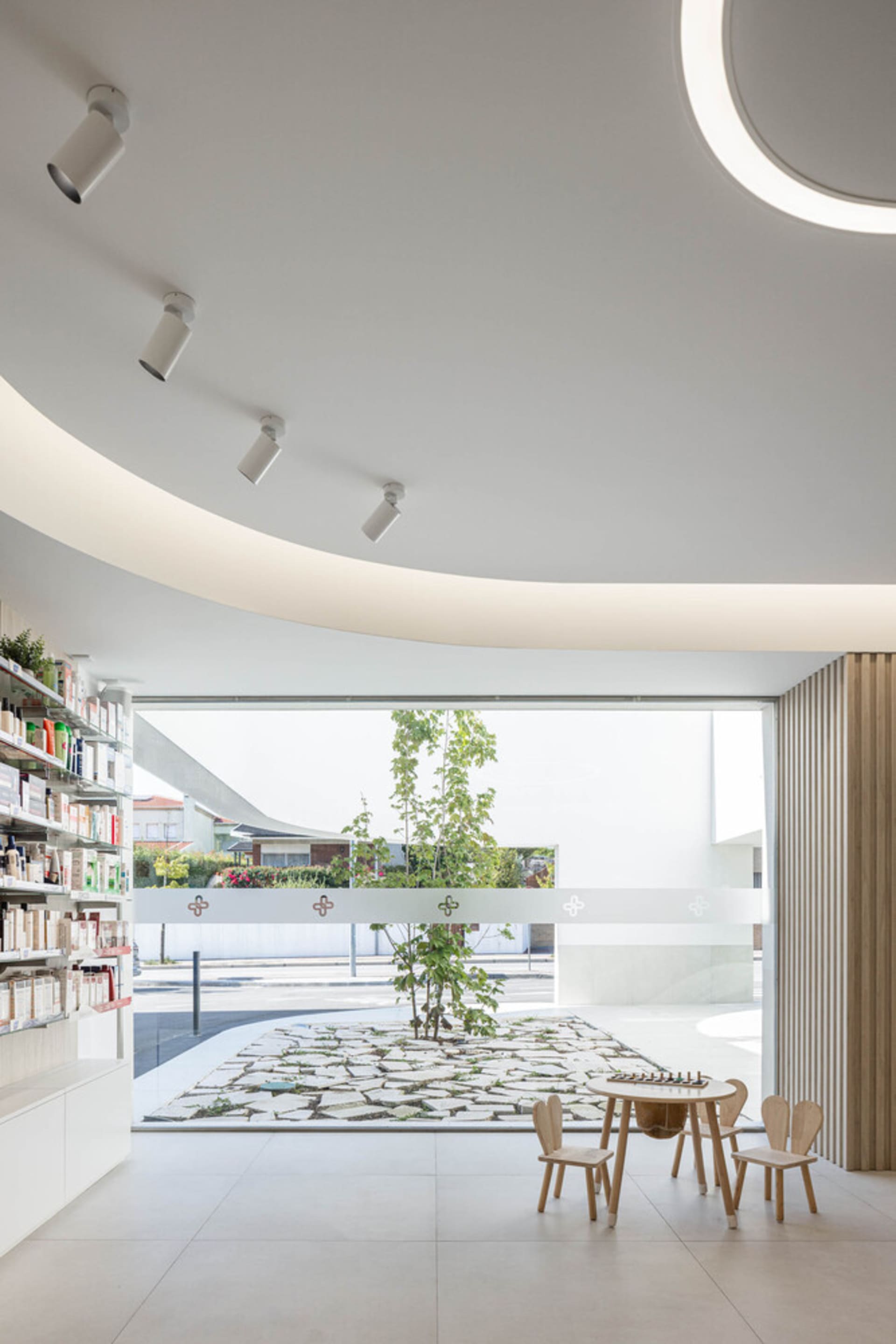 A modern commercial interior featuring a white concrete floor and minimalist design elements.