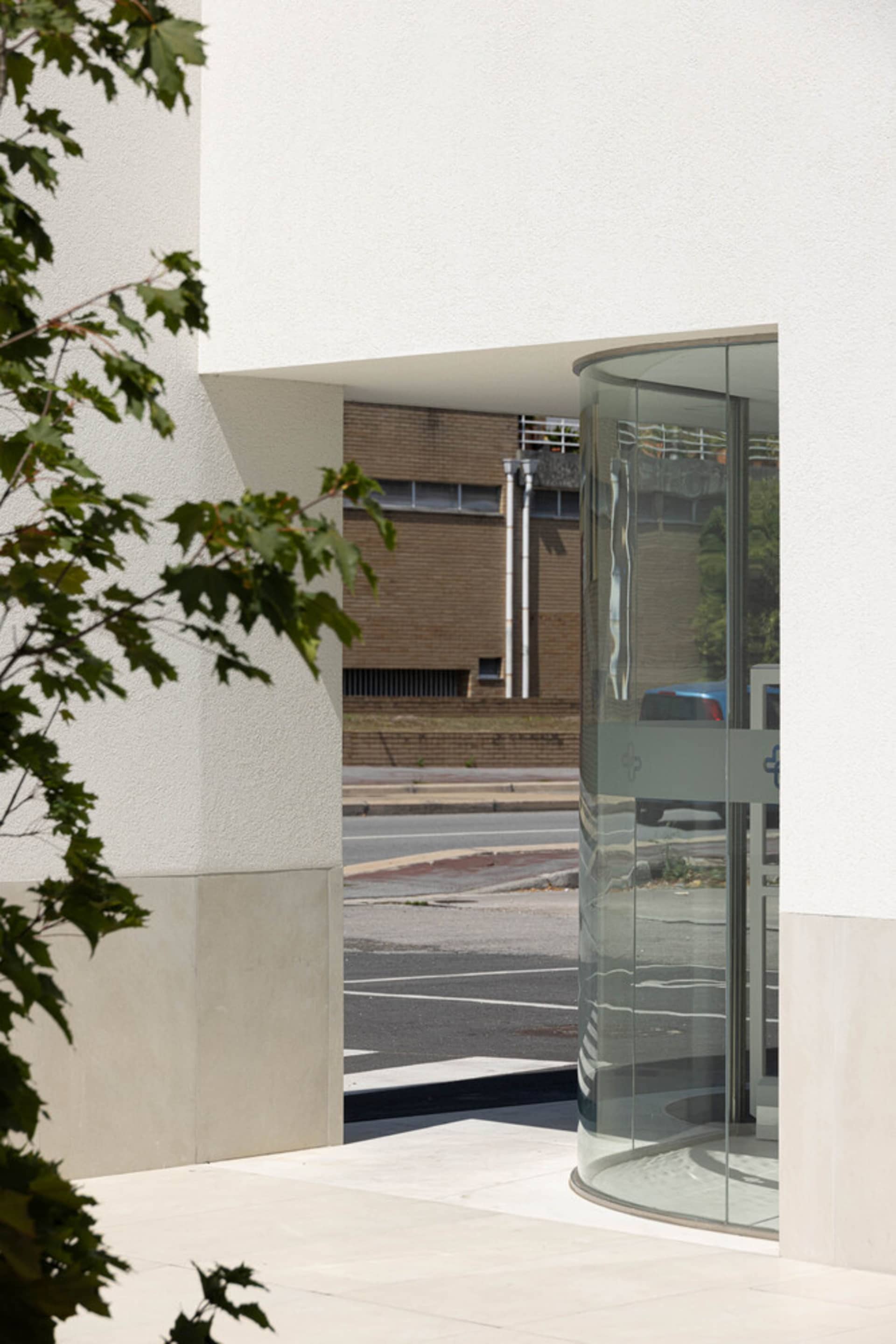 A modern entrance with a glass door, featuring sleek, clean lines and a clean, minimalist design.
