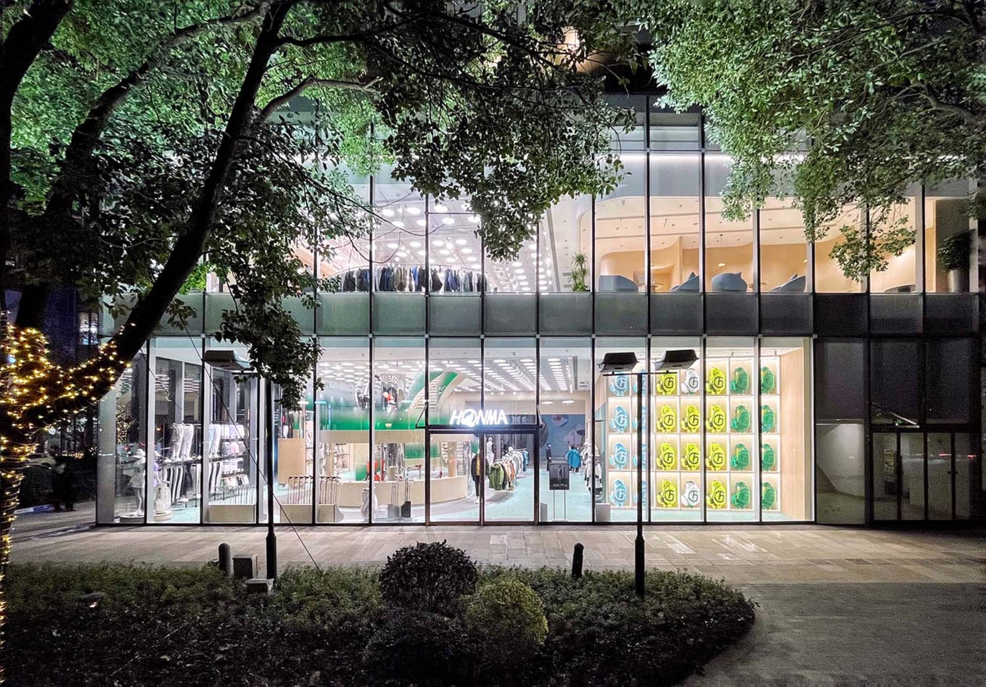 Modern retail storefront featuring glass, steel, and concrete materials.
