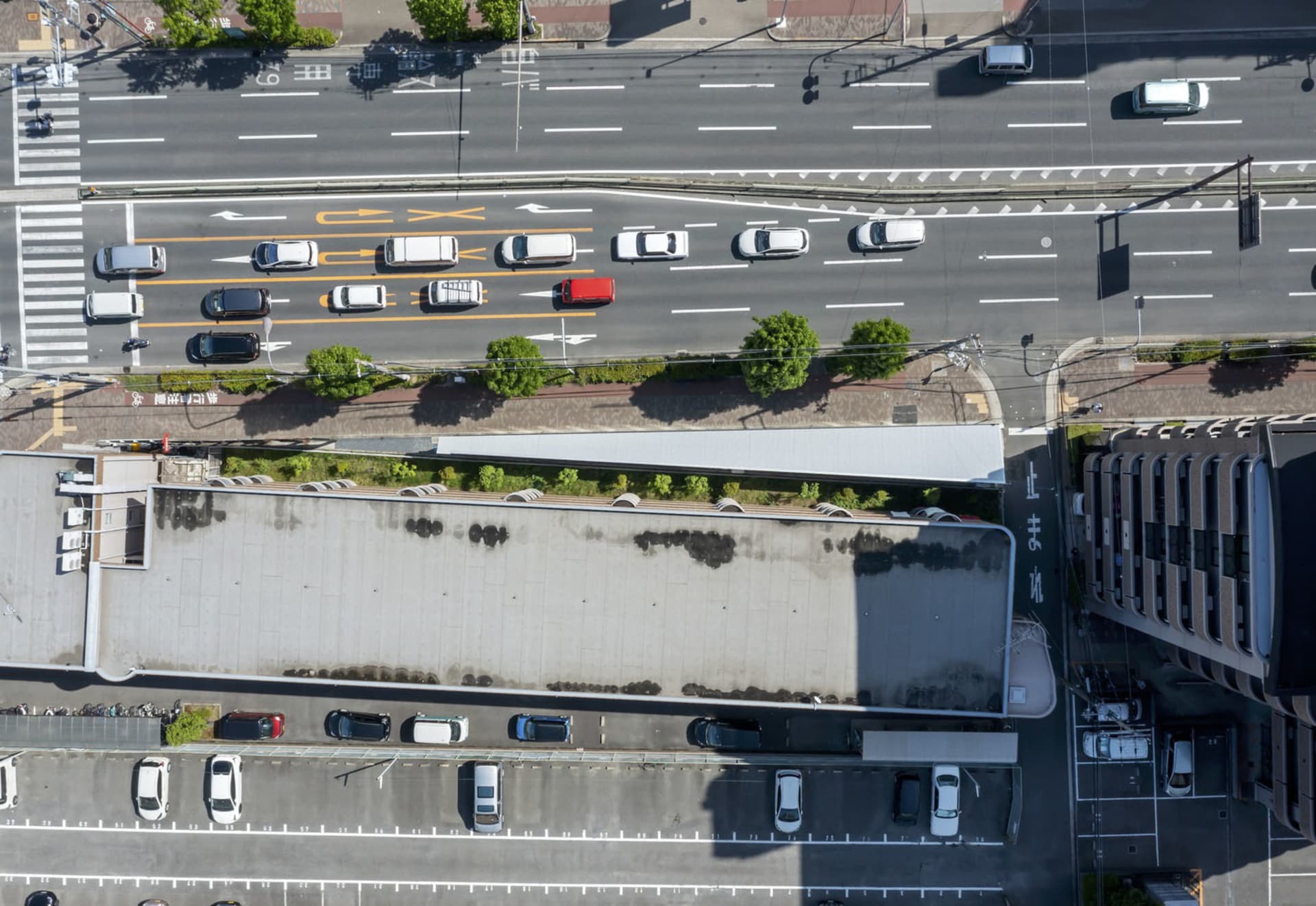 Aerial view of a city street featuring concrete, asphalt, and metal elements.