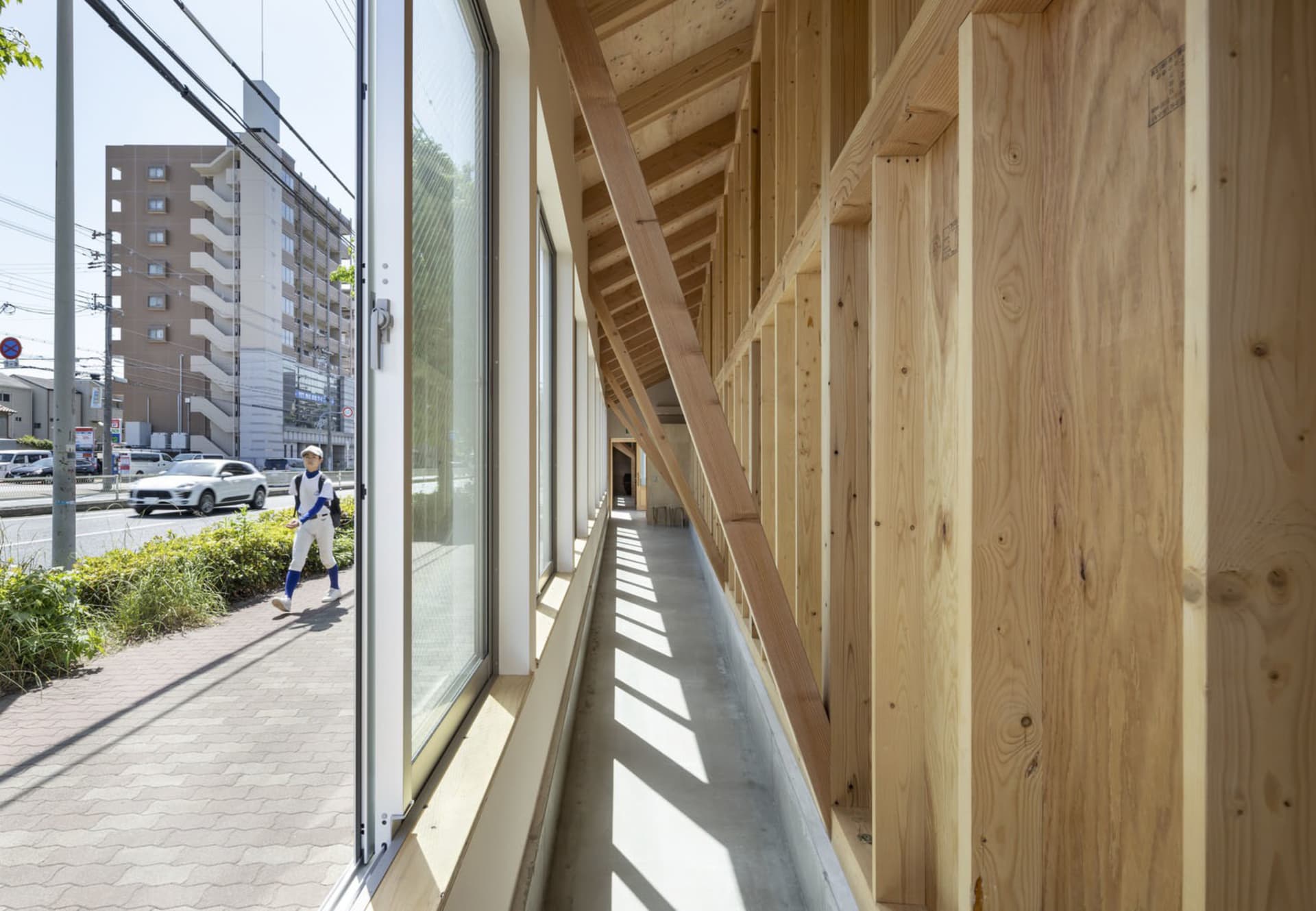 Modern interior design featuring a hallway with wooden frame and large glass windows.