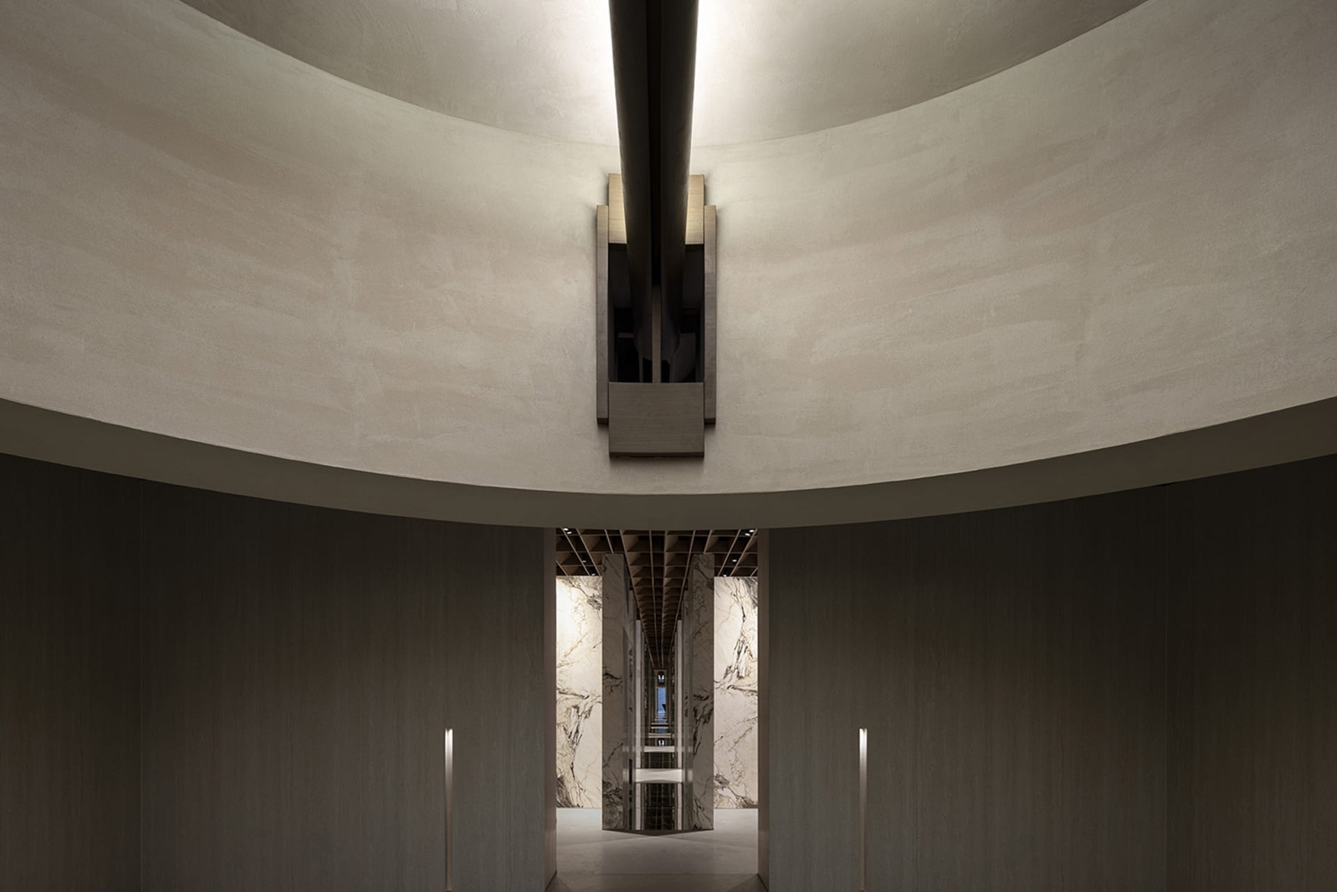 Modern interior featuring concrete columns and a circular ceiling.