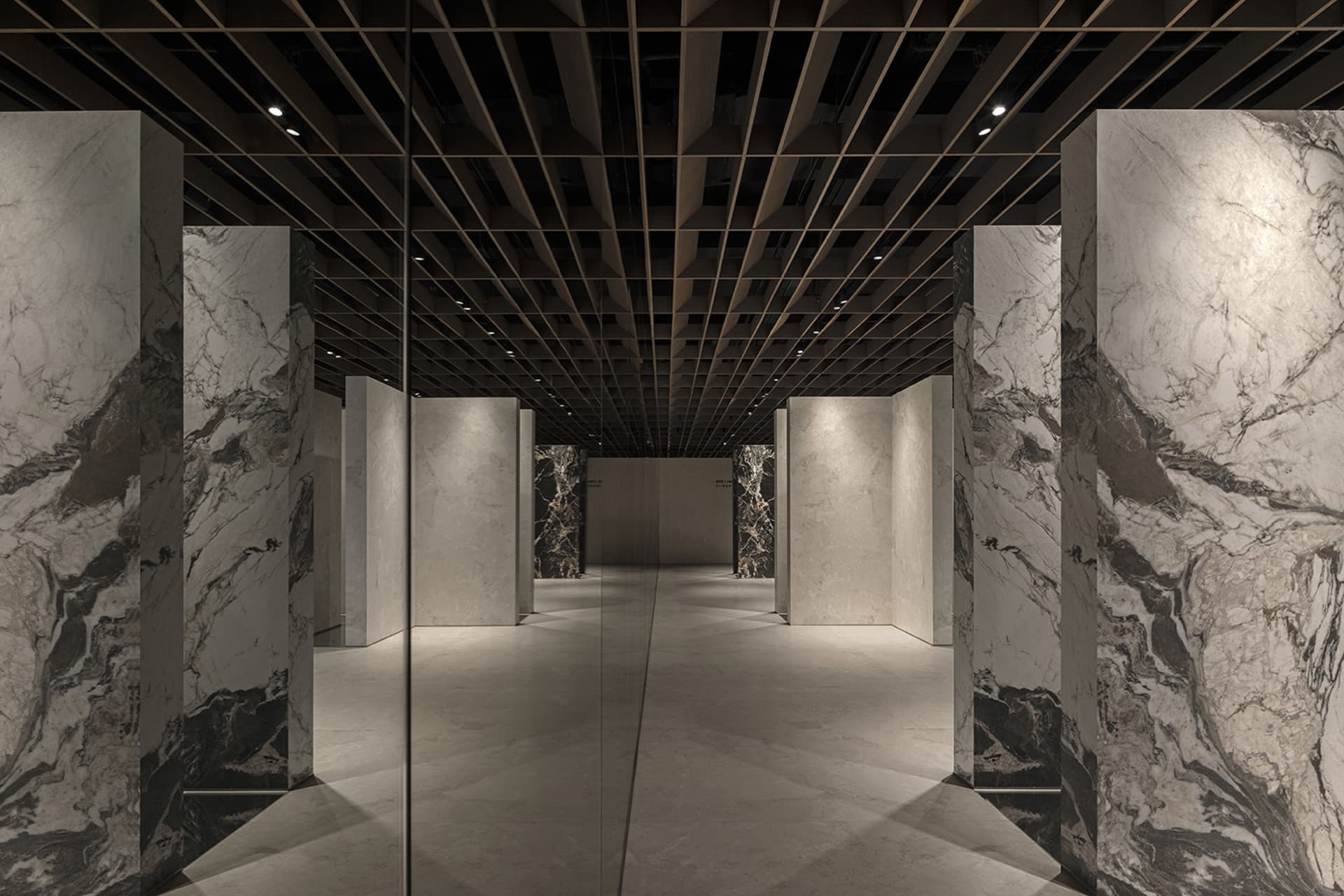 A minimalist interior space featuring marble walls and floors.