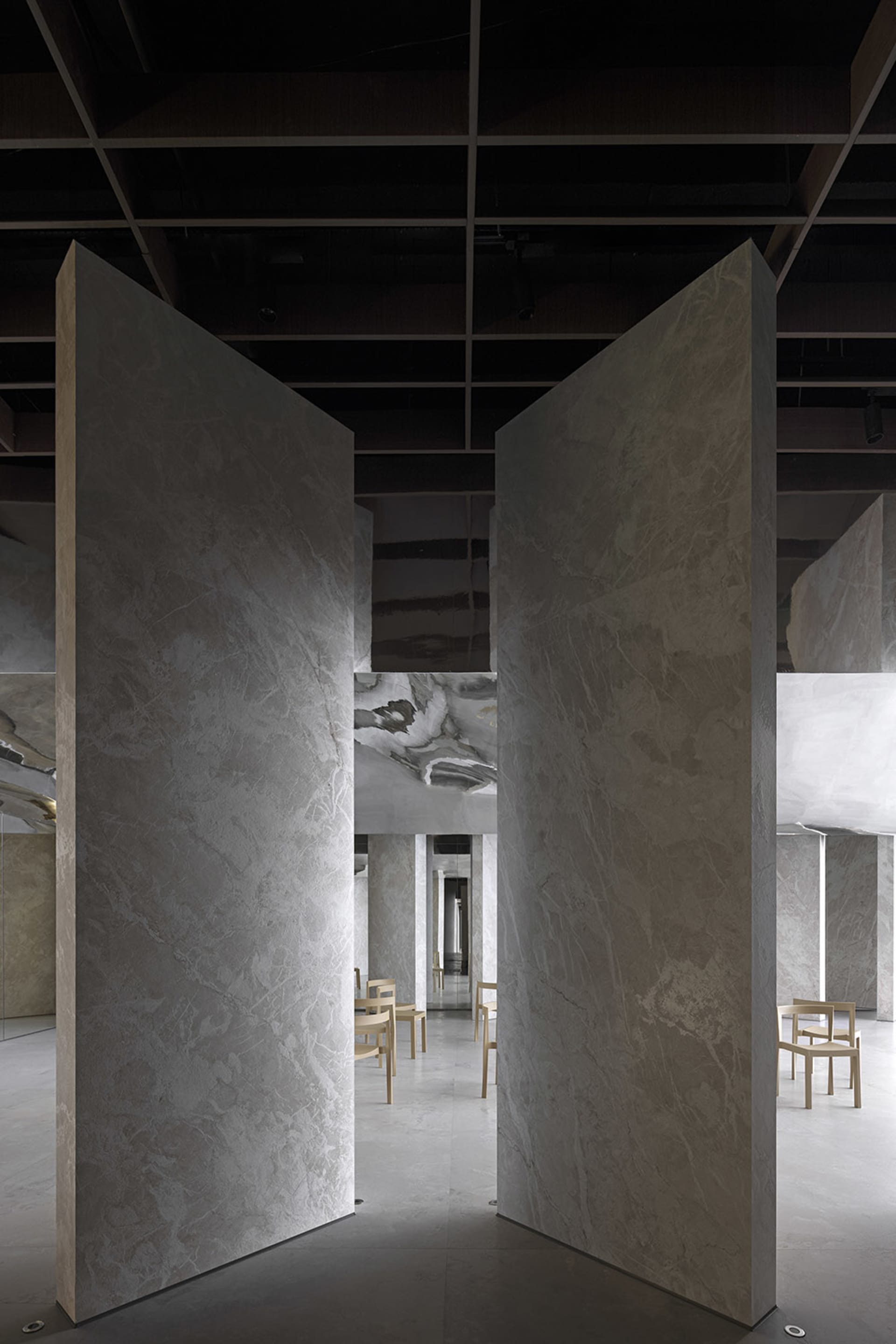 Modern restaurant interior featuring marble walls and floors.