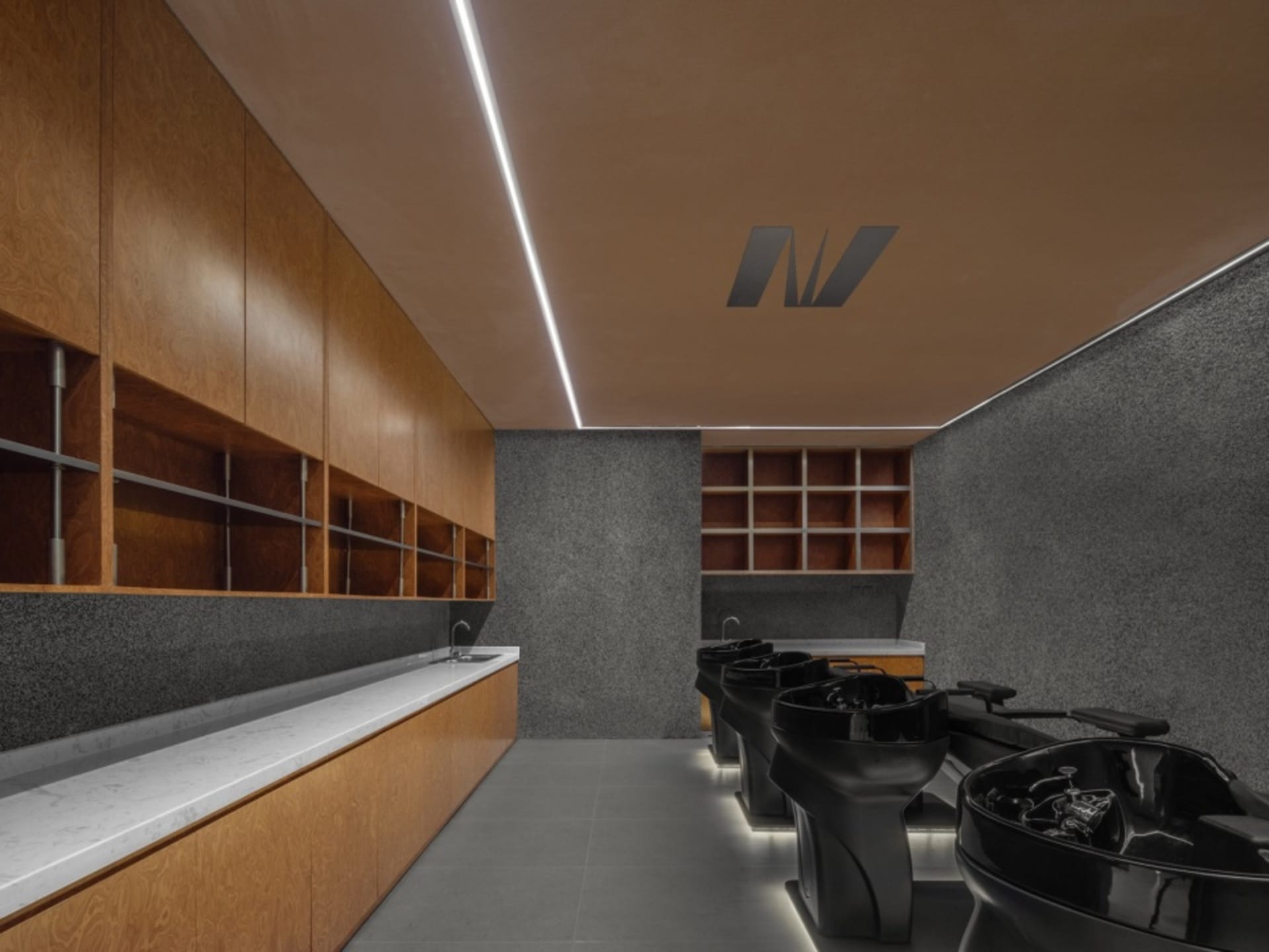 Modern commercial interior featuring minimalist design elements with wood and granite surfaces.