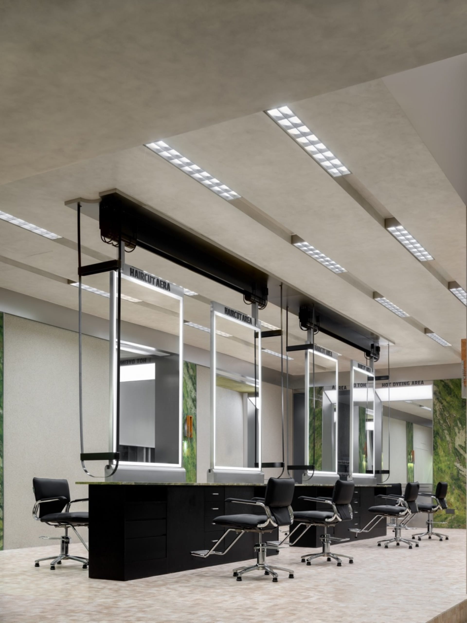 A modern hair salon featuring a sleek, concrete interior design.