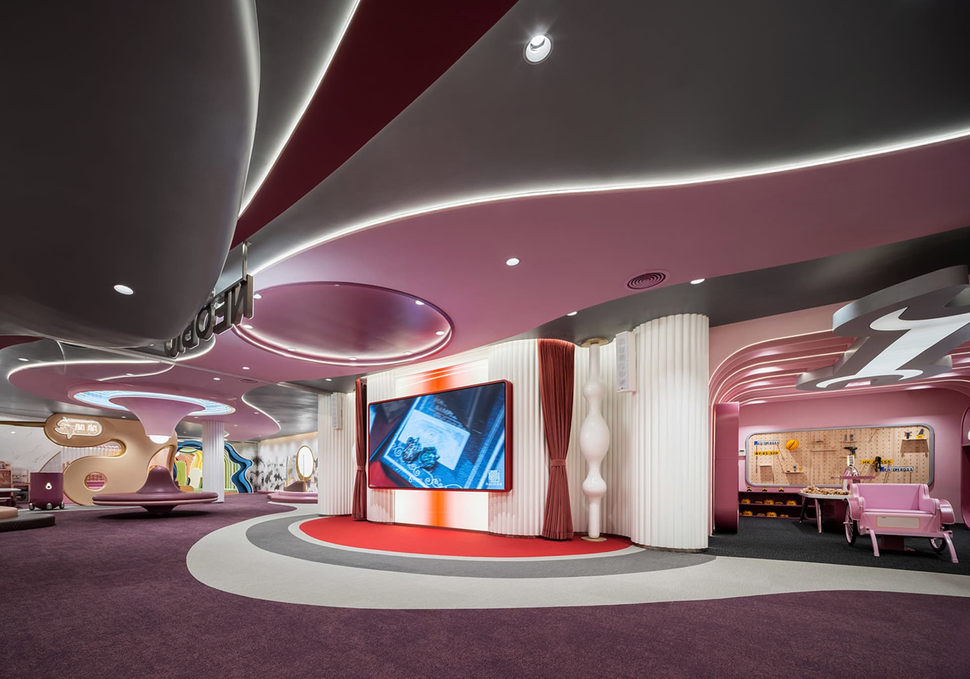 A modern retail space with a futuristic design featuring metallic elements and a curved canopy.