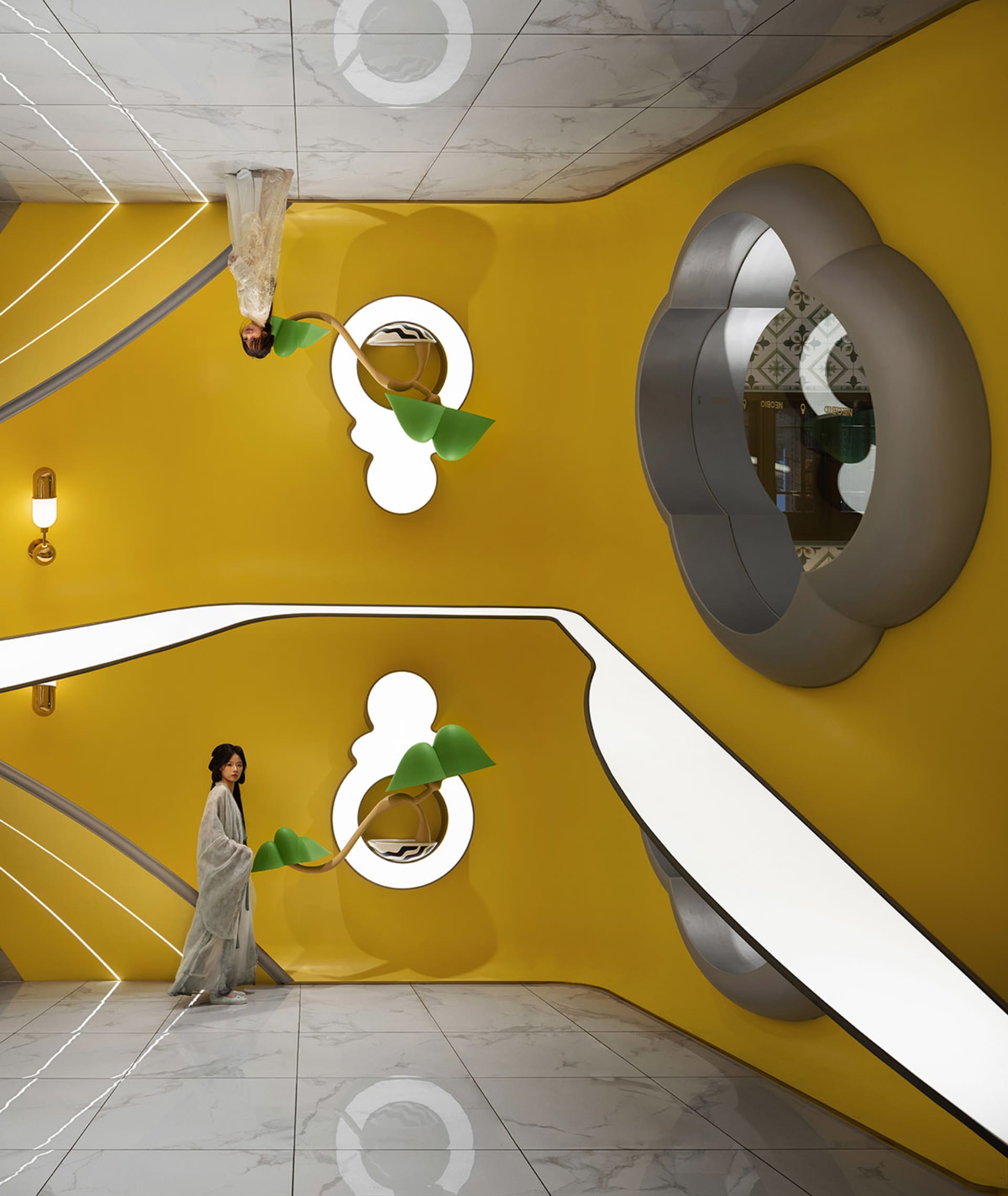A modern interior design featuring vibrant yellow walls with sculptural wall art and a person standing in front of it.