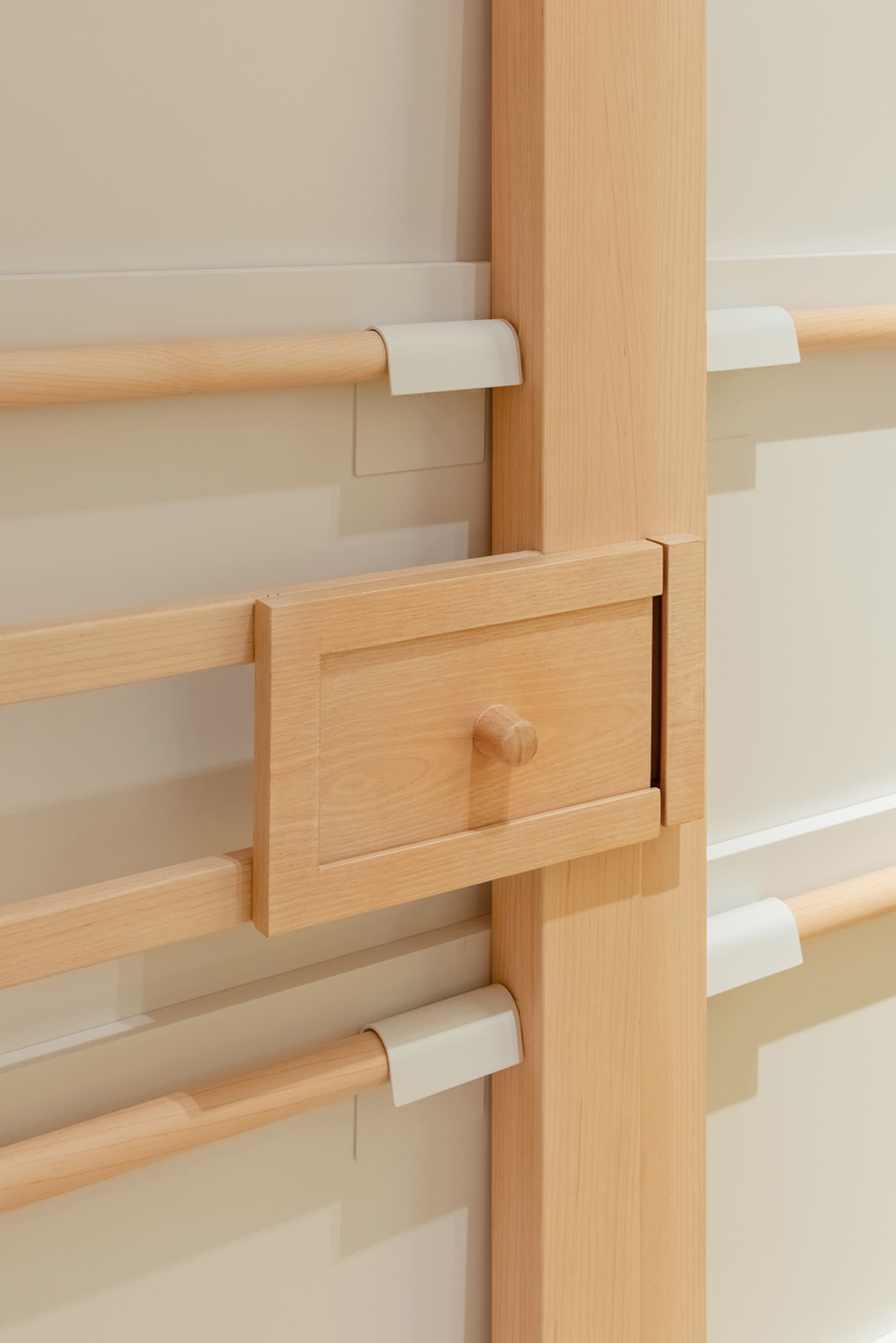A modern minimalist wooden cabinet with a single drawer and sleek lines.