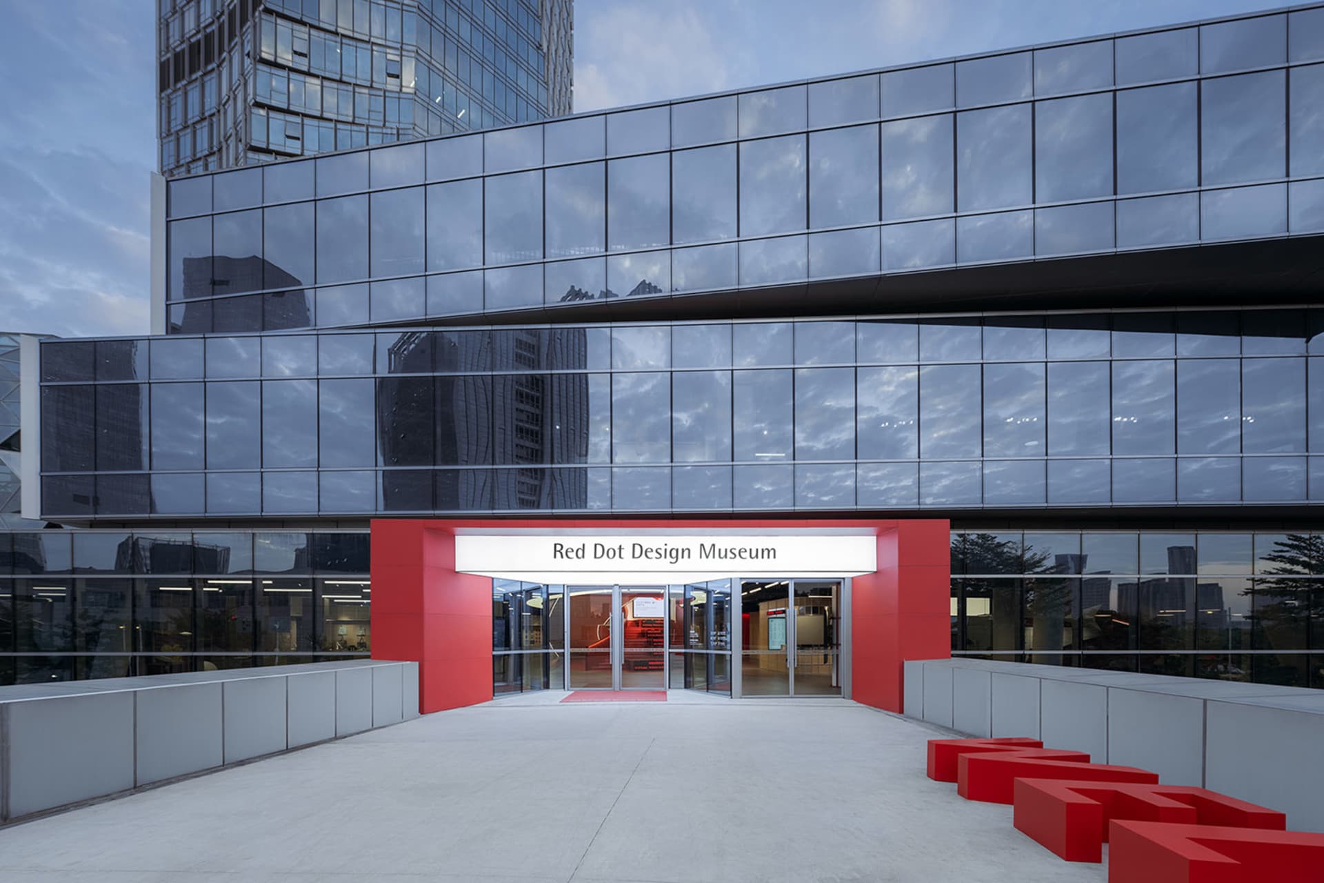 A modern architectural design featuring a glass and metal exterior at a museum.