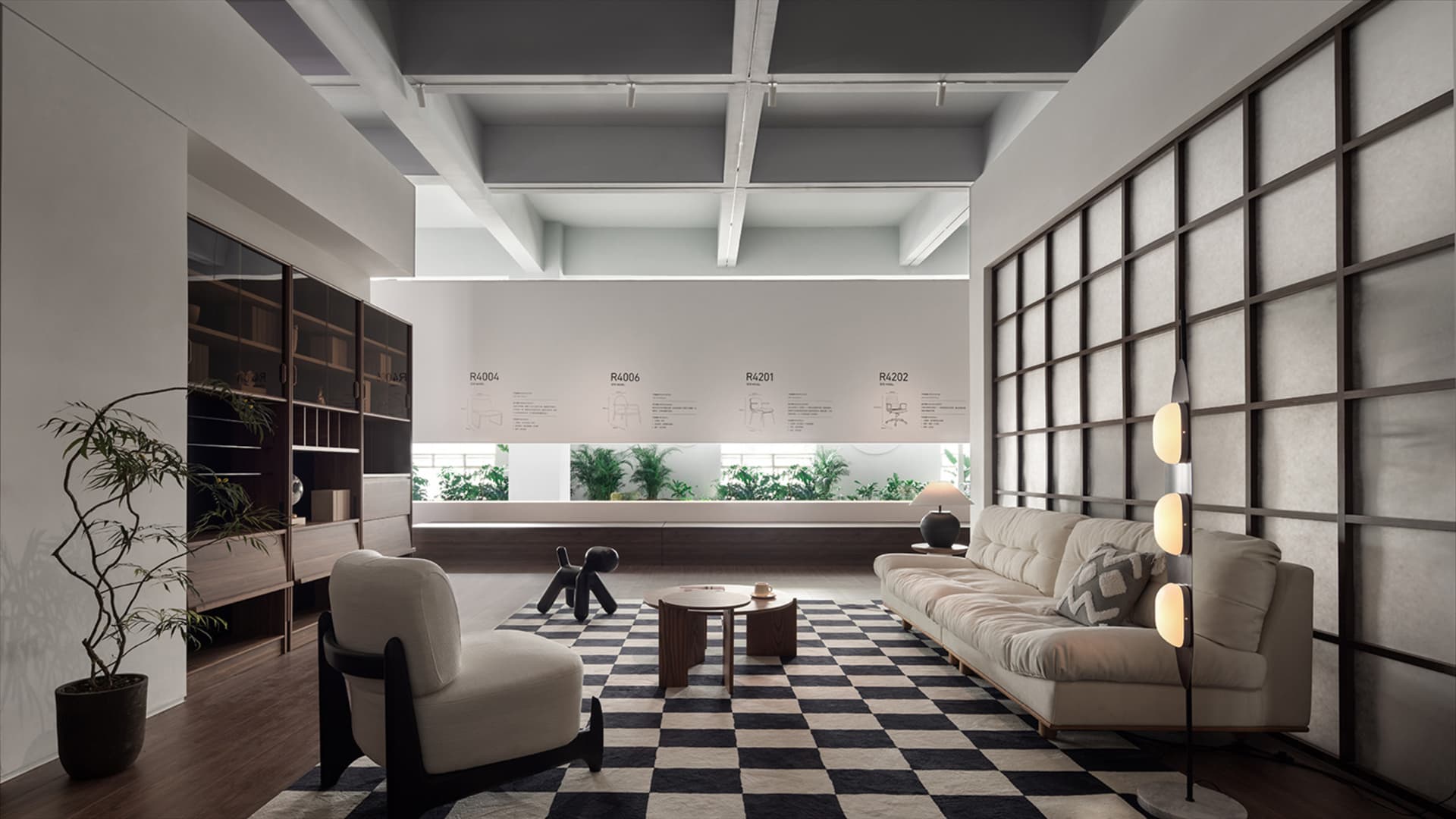 A minimalist living room with modern furniture, including a white sofa, black chair, and checkered rug.
