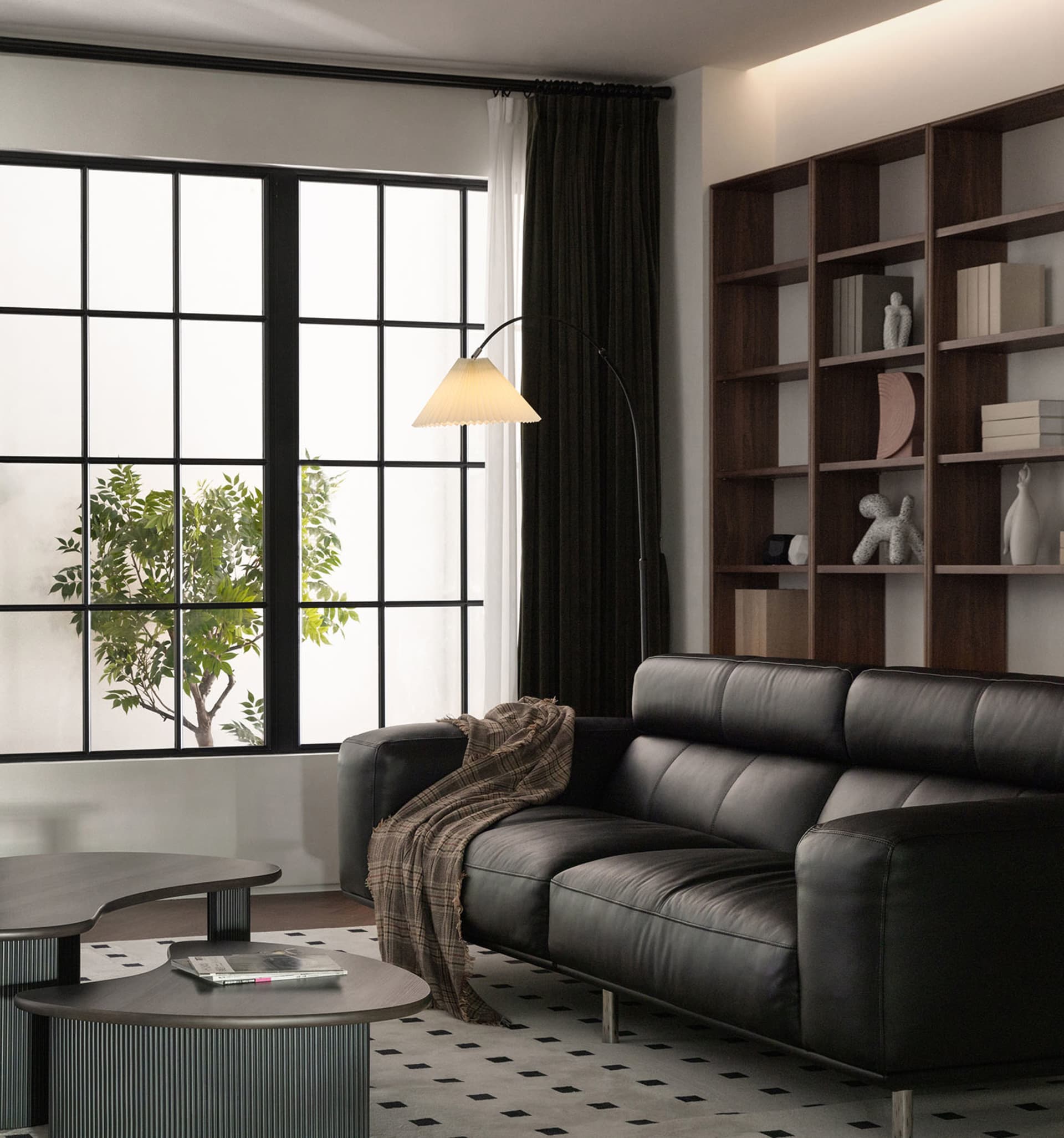 Modern living room with a black leather couch, wooden shelves, and a glass coffee table.