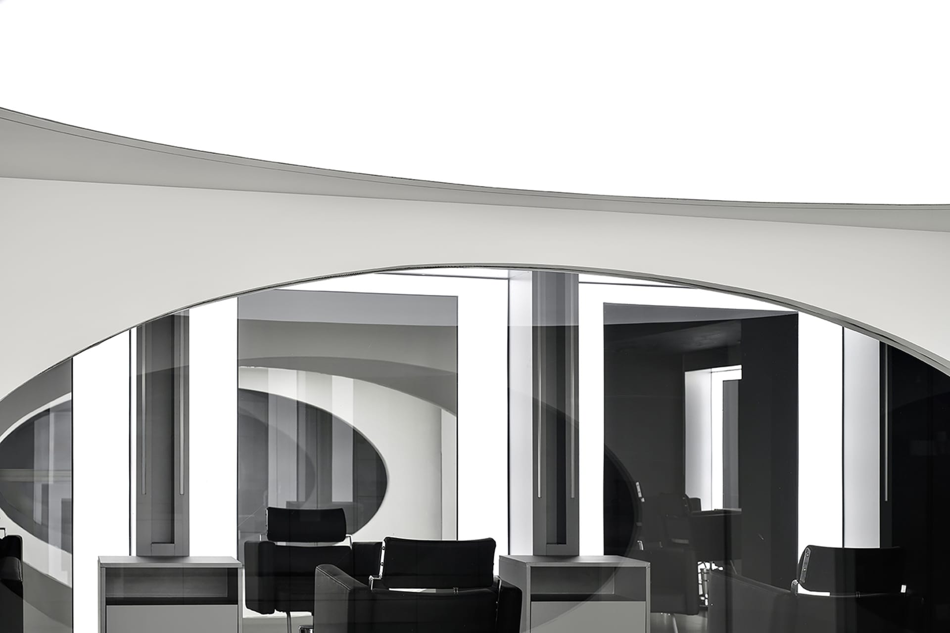 Modern office space with glass and concrete walls and floors.
