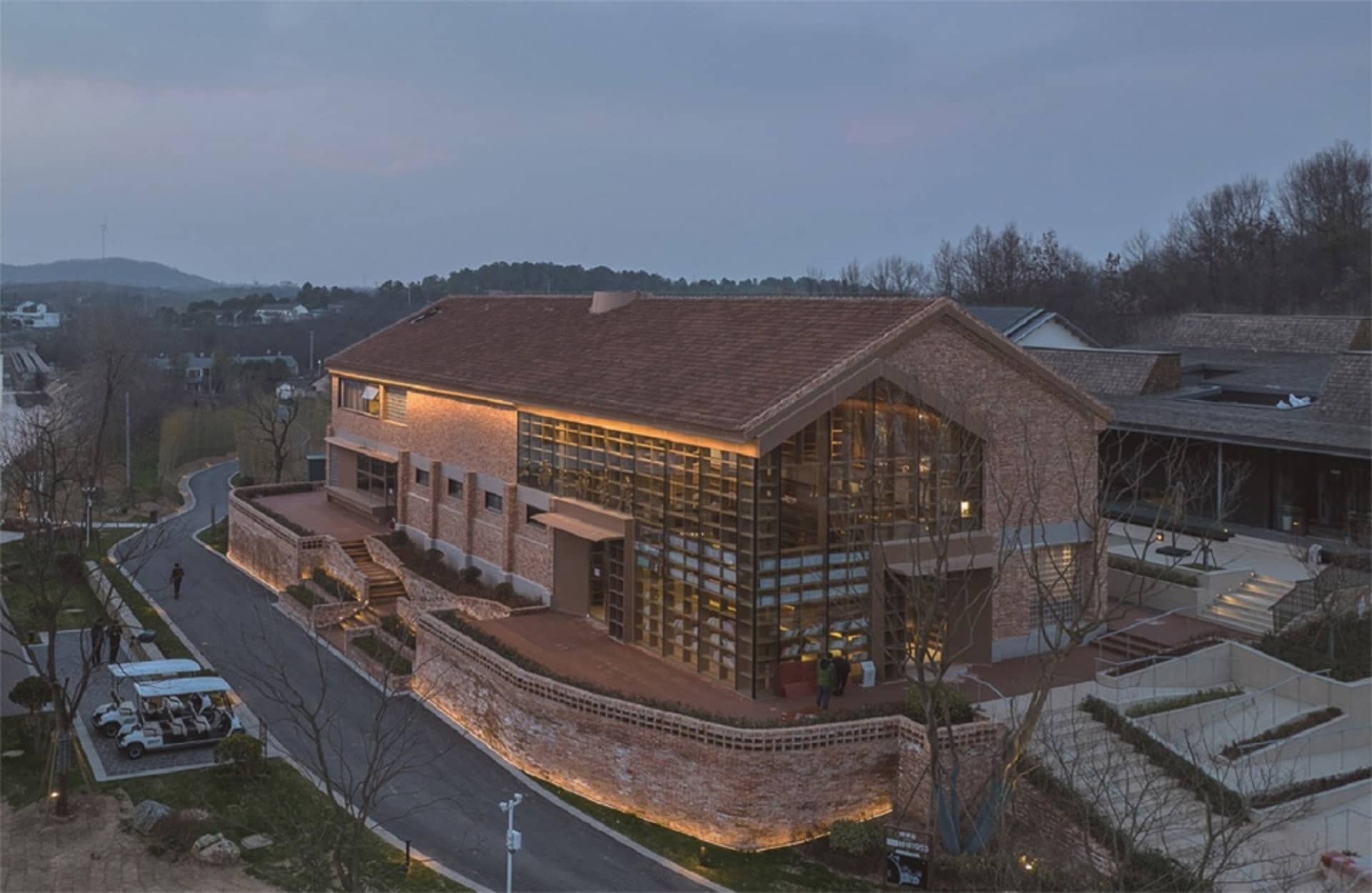 A modern building with a brick exterior during sunset