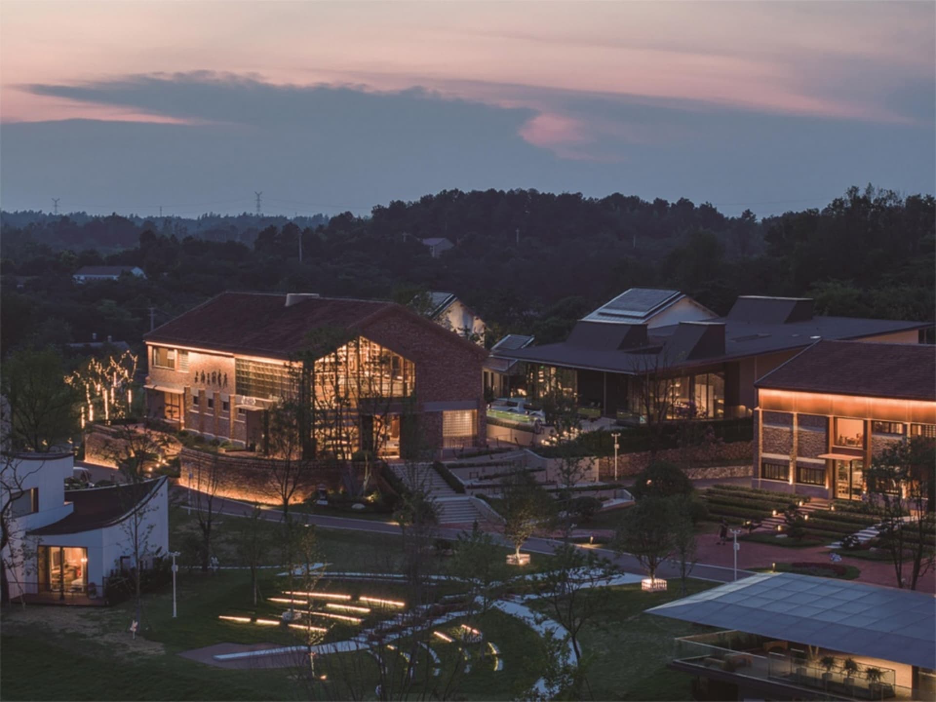 A modern residential area with brick houses during dusk.