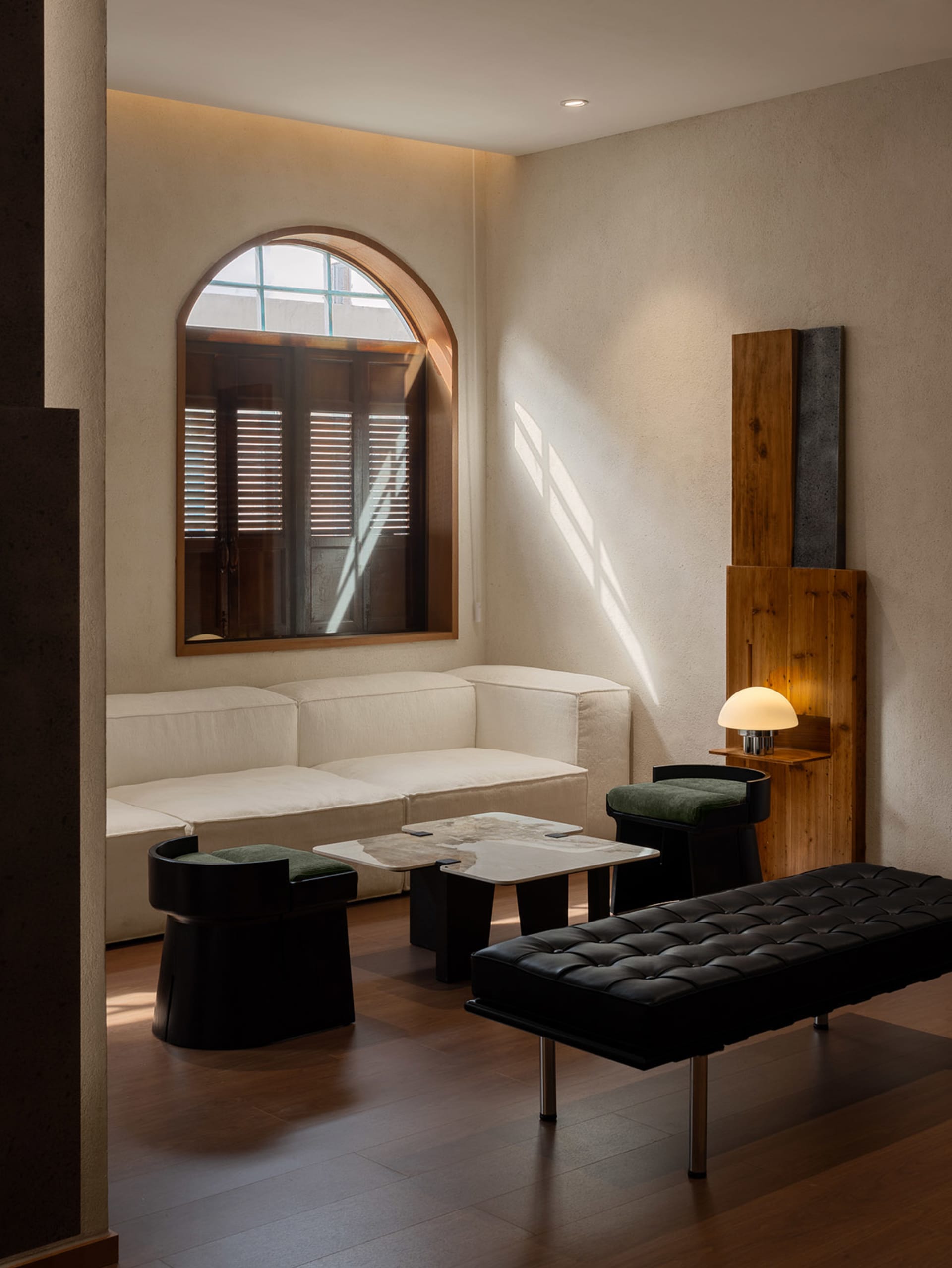 A minimalist living room featuring soft furnishings and a sleek, modern design.