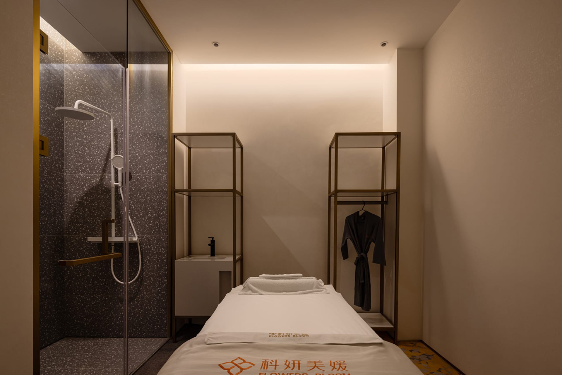 A minimalist bedroom with terrazzo flooring and a single bed.