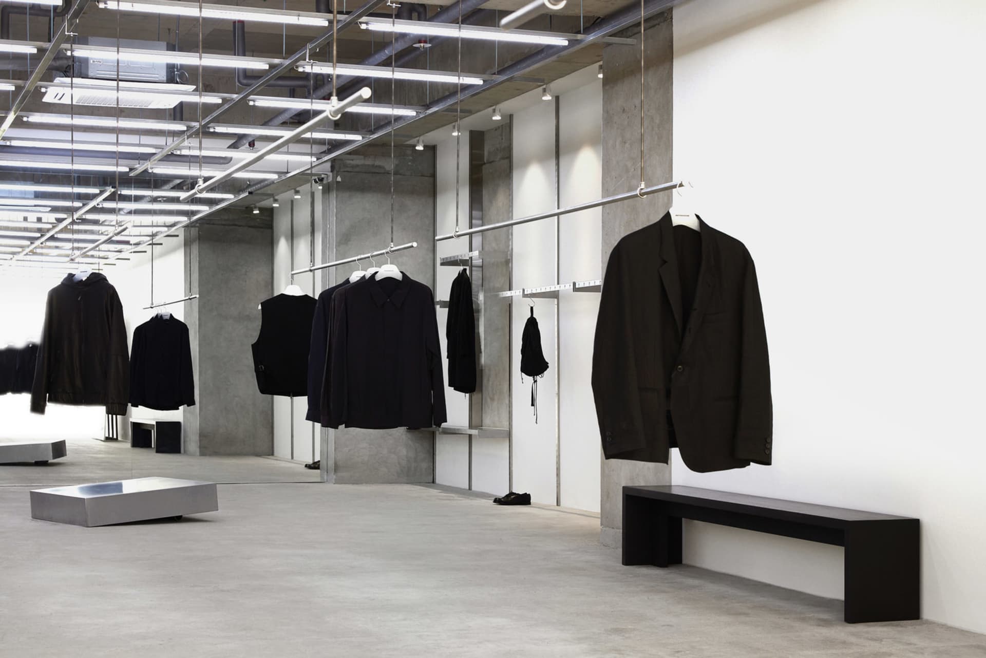 Modern retail space featuring concrete walls and metal railings.
