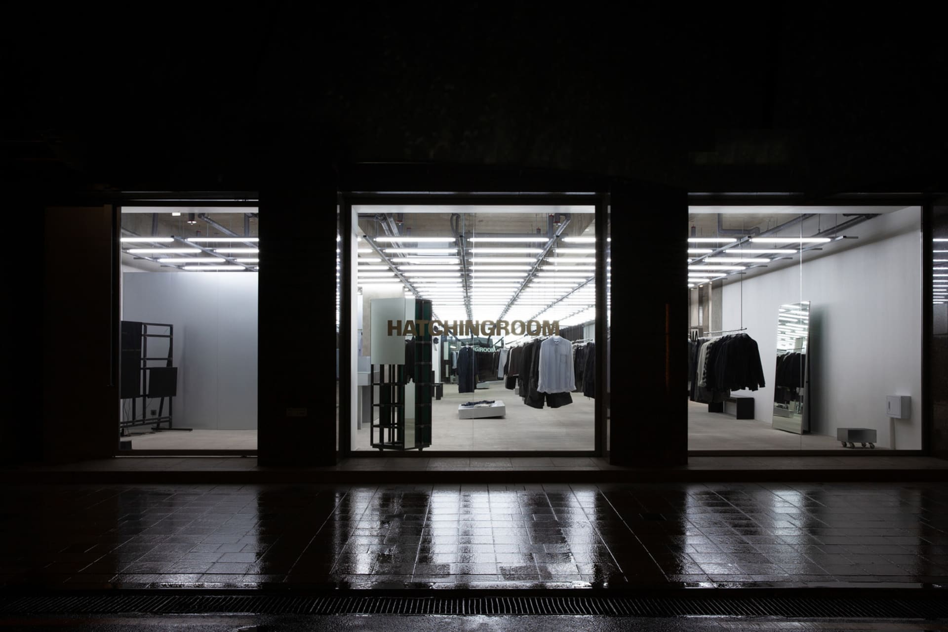 Modern retail space featuring metal, glass, and concrete materials