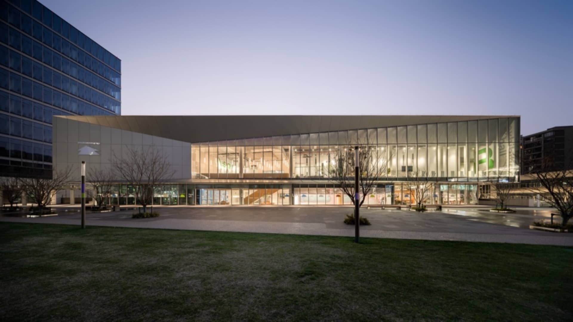 A modern shopping center with a glass and concrete exterior.