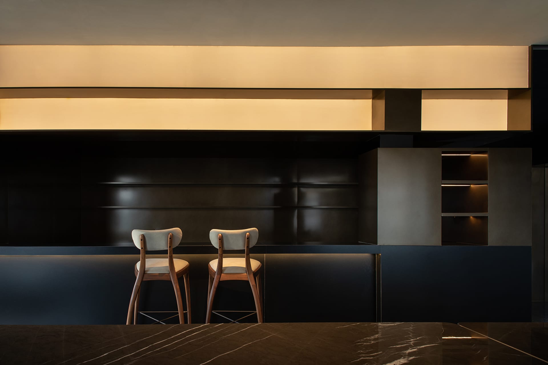 Modern bar area featuring marble and glass materials, designed for retail settings.