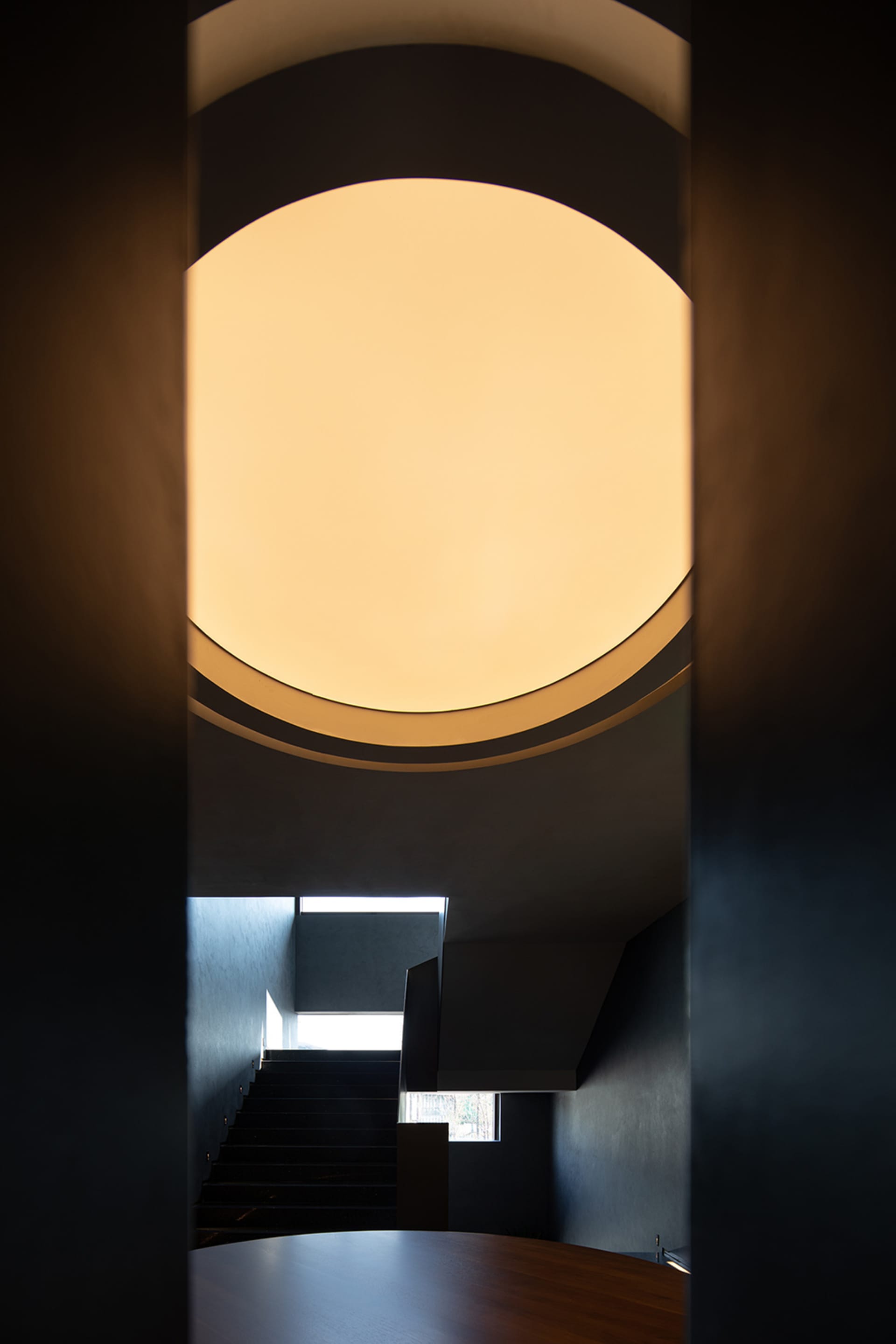 A modern minimalist stairwell with a glass and metal design.