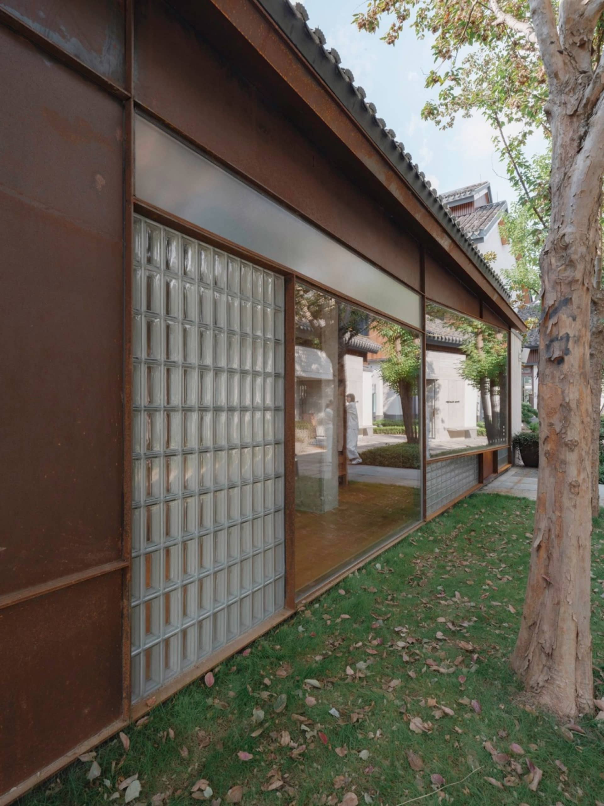 Modern retail storefront with glass block windows and concrete roofing