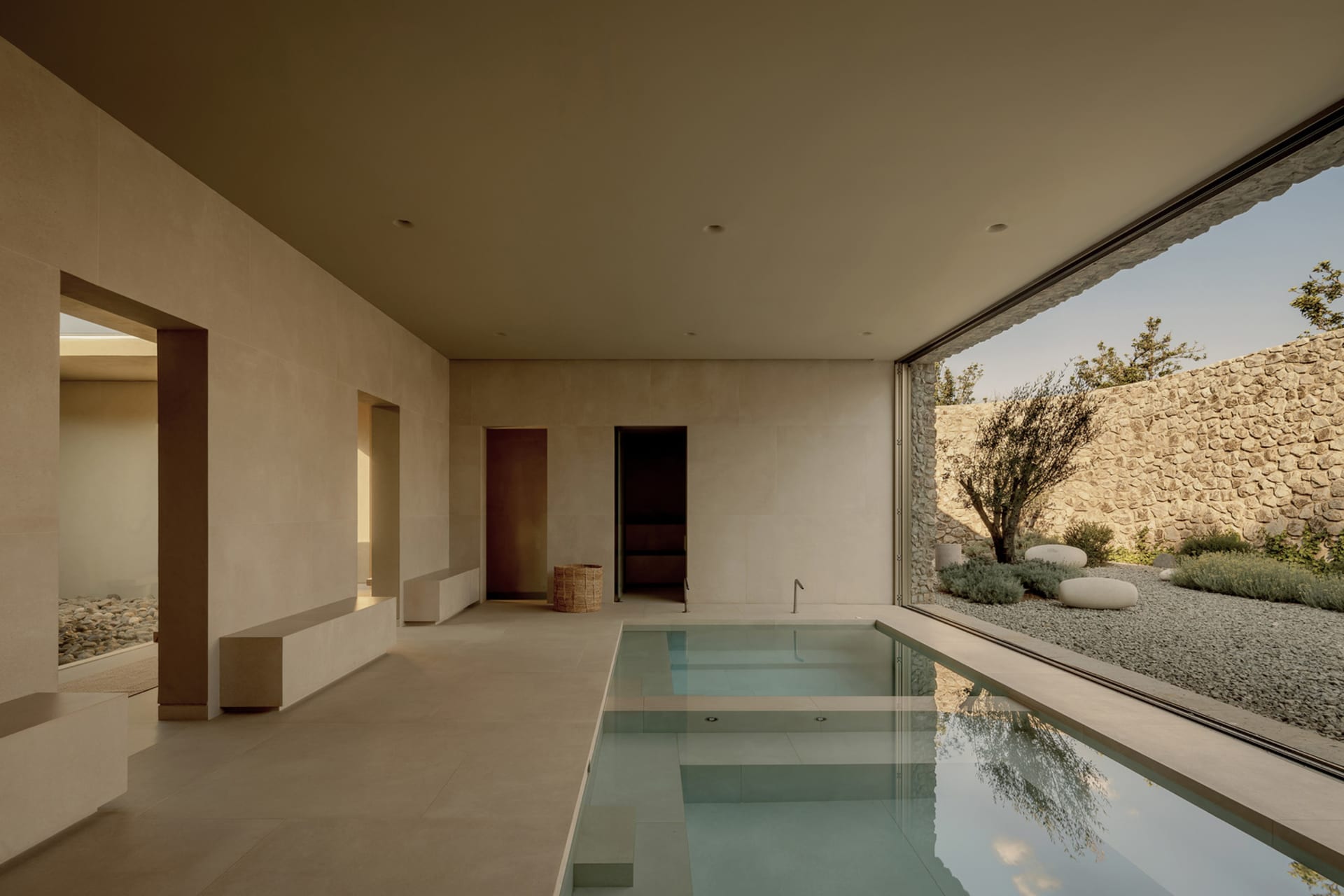 Modern minimalist residential swimming pool constructed from concrete and glass.