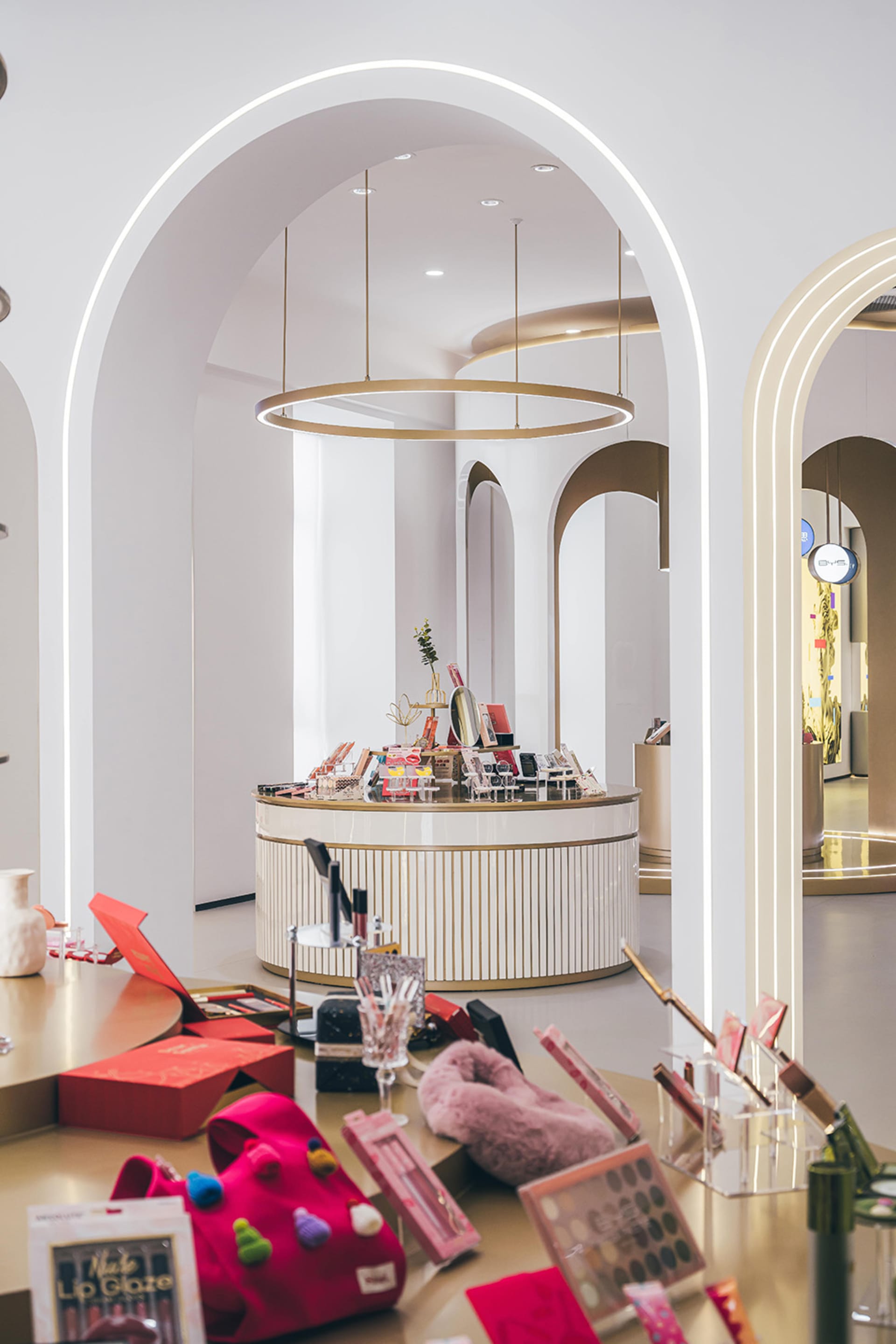 A modern retail store with a circular counter and colorful products on display.