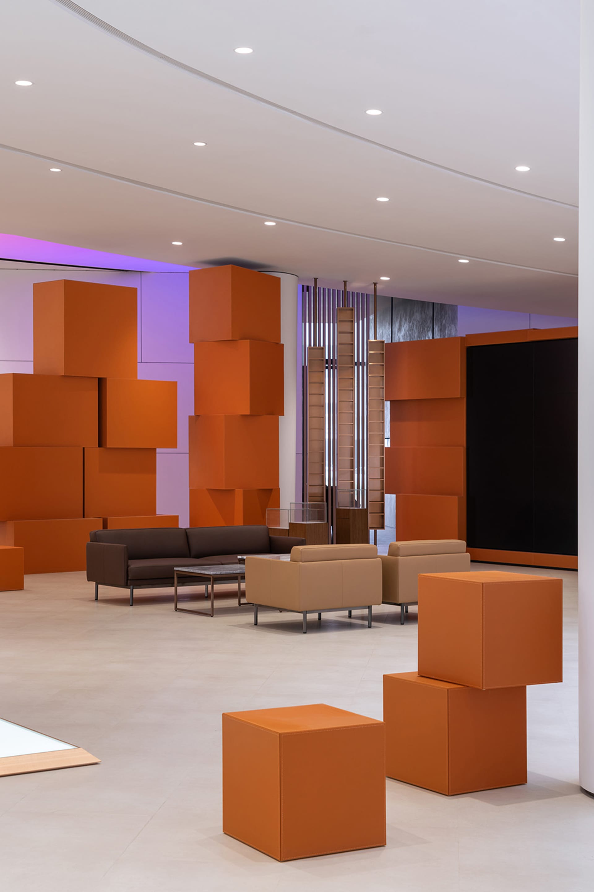 A modern lobby featuring orange cubes and contemporary furniture.