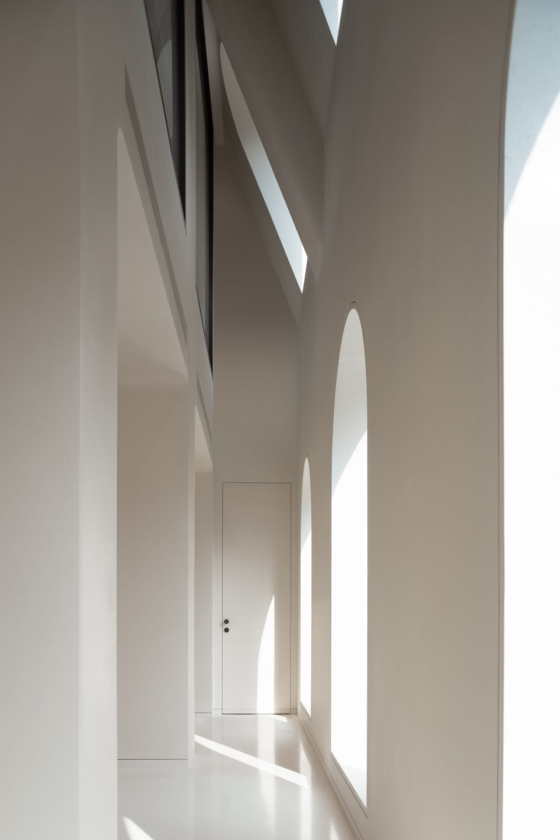 Minimalist space with white interiors, showing clean lines and open design.