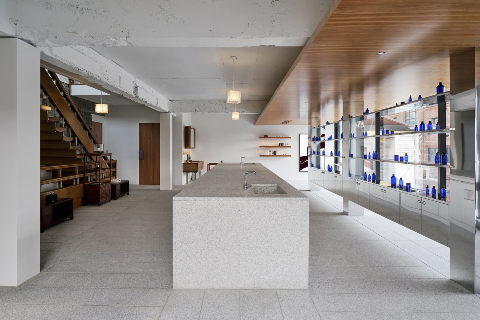 A minimalist office space featuring concrete and glass materials.