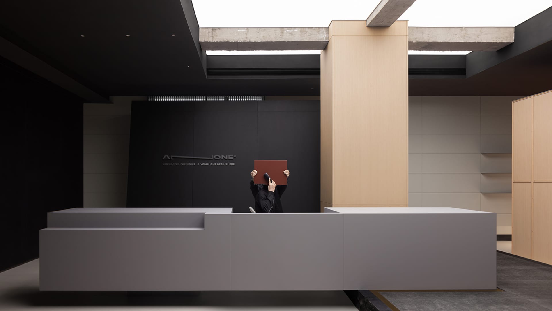 A modern lobby interior with concrete walls and minimalist design features.
