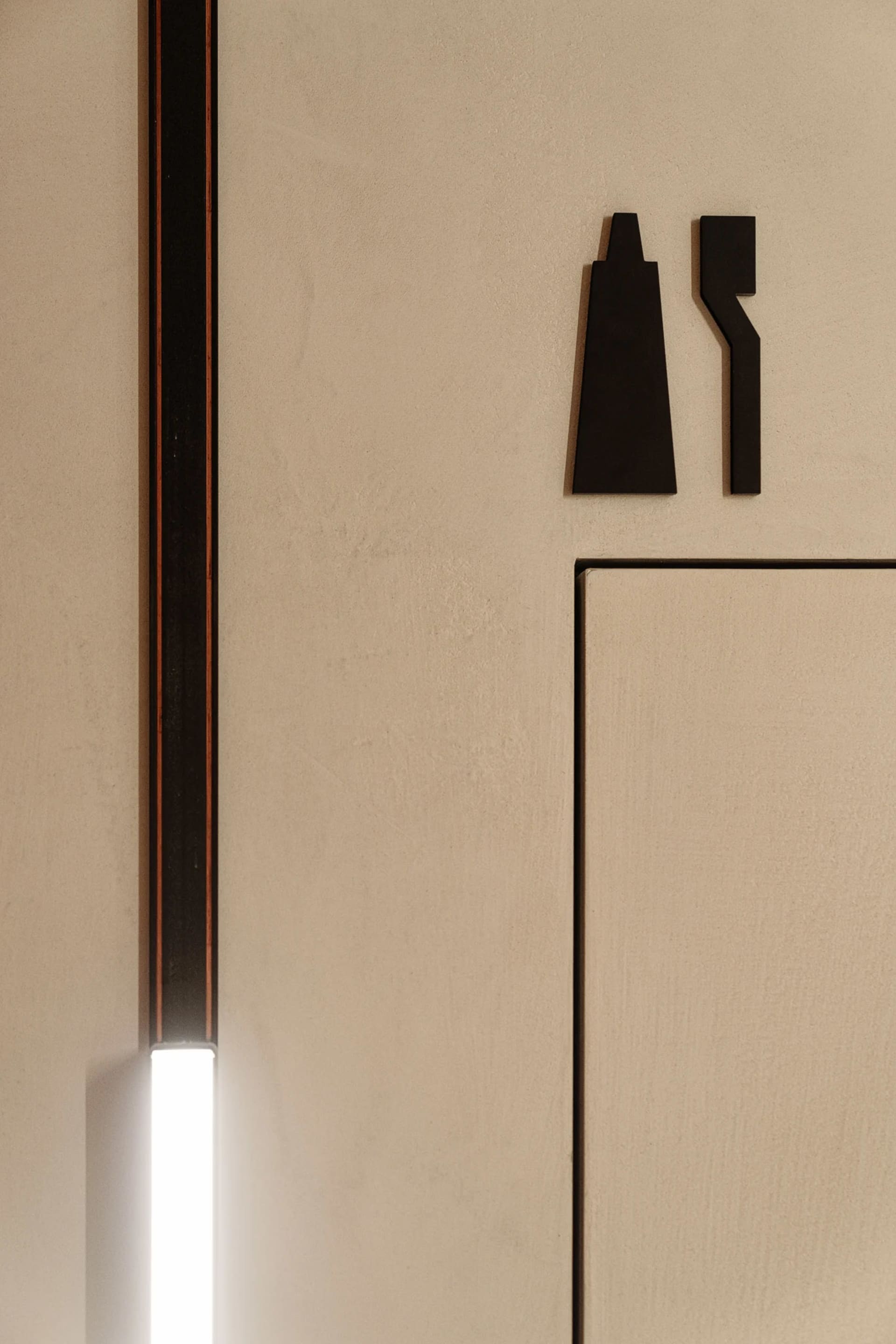 Simple, geometric door signs made of metal.