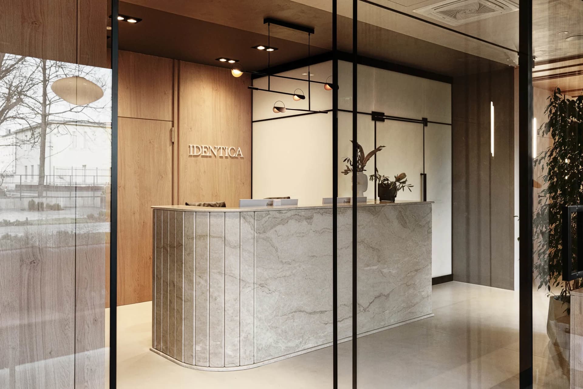 A modern minimalist office lobby with a stone counter.