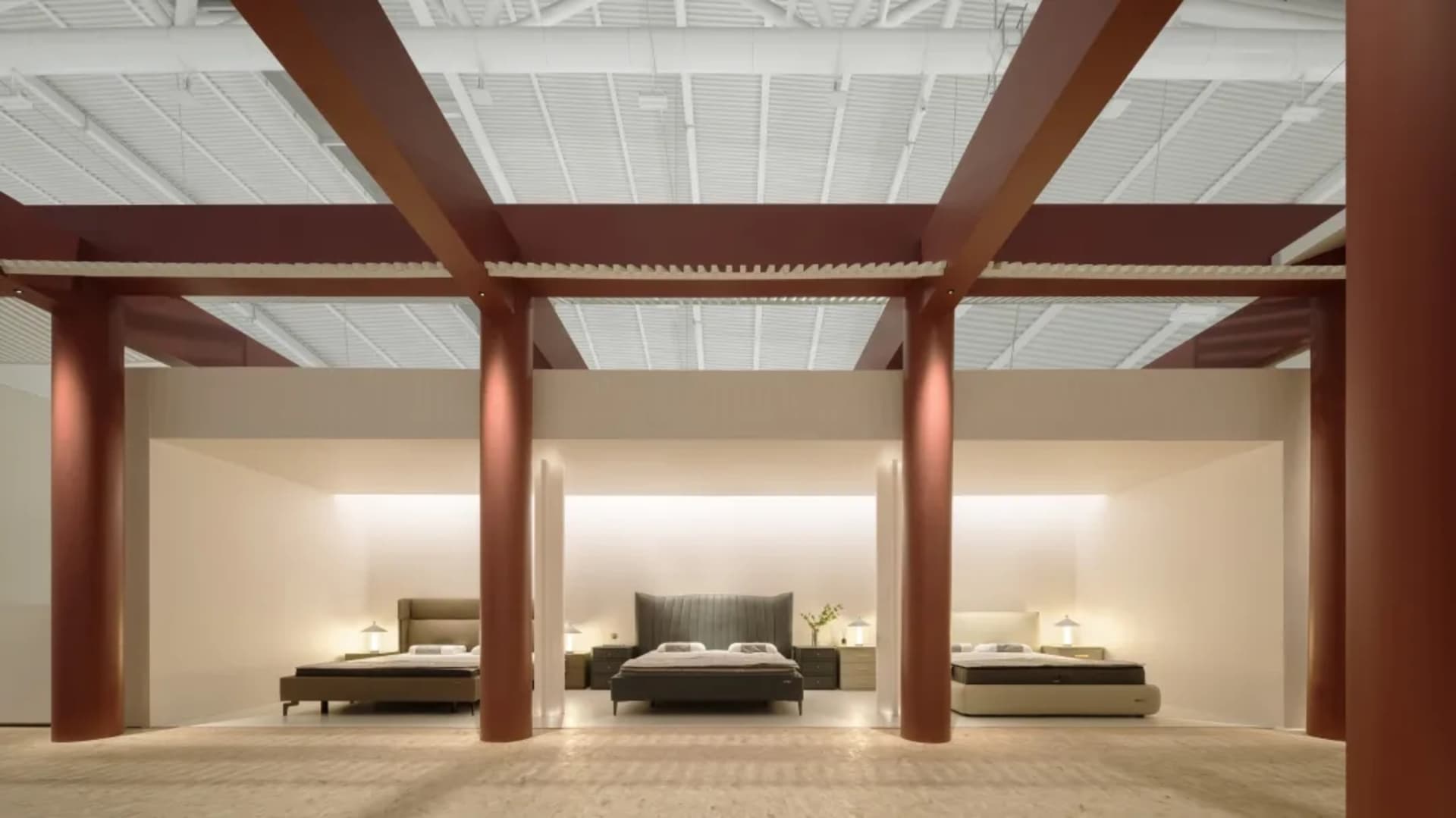 A modern bedroom showcasing sleek, minimalist concrete furniture and contemporary lighting fixtures.