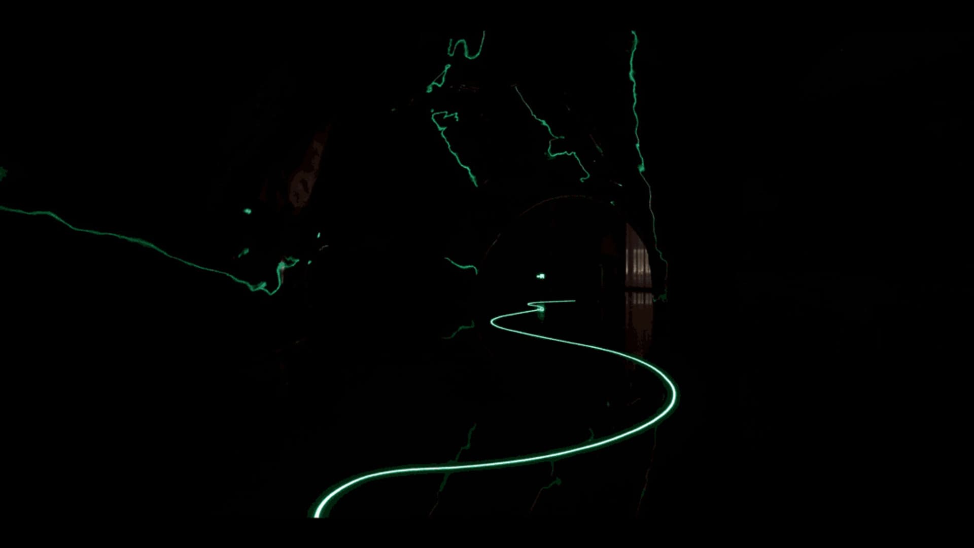 A minimalistic tunnel with a winding electric light guiding the way